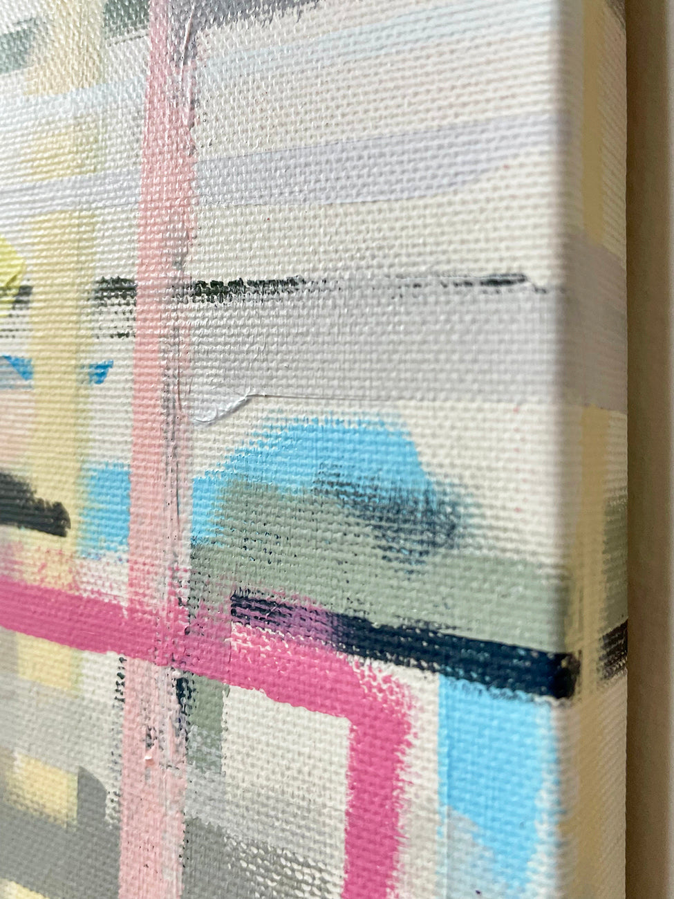 A painting with pink, blue, yellow, and green squares on a white background.