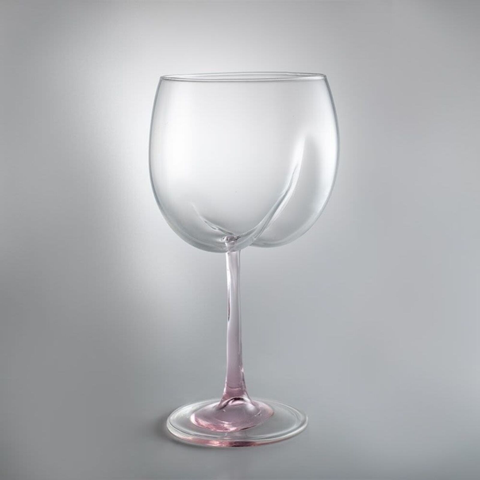 A pair of wine glasses sitting next to each other.