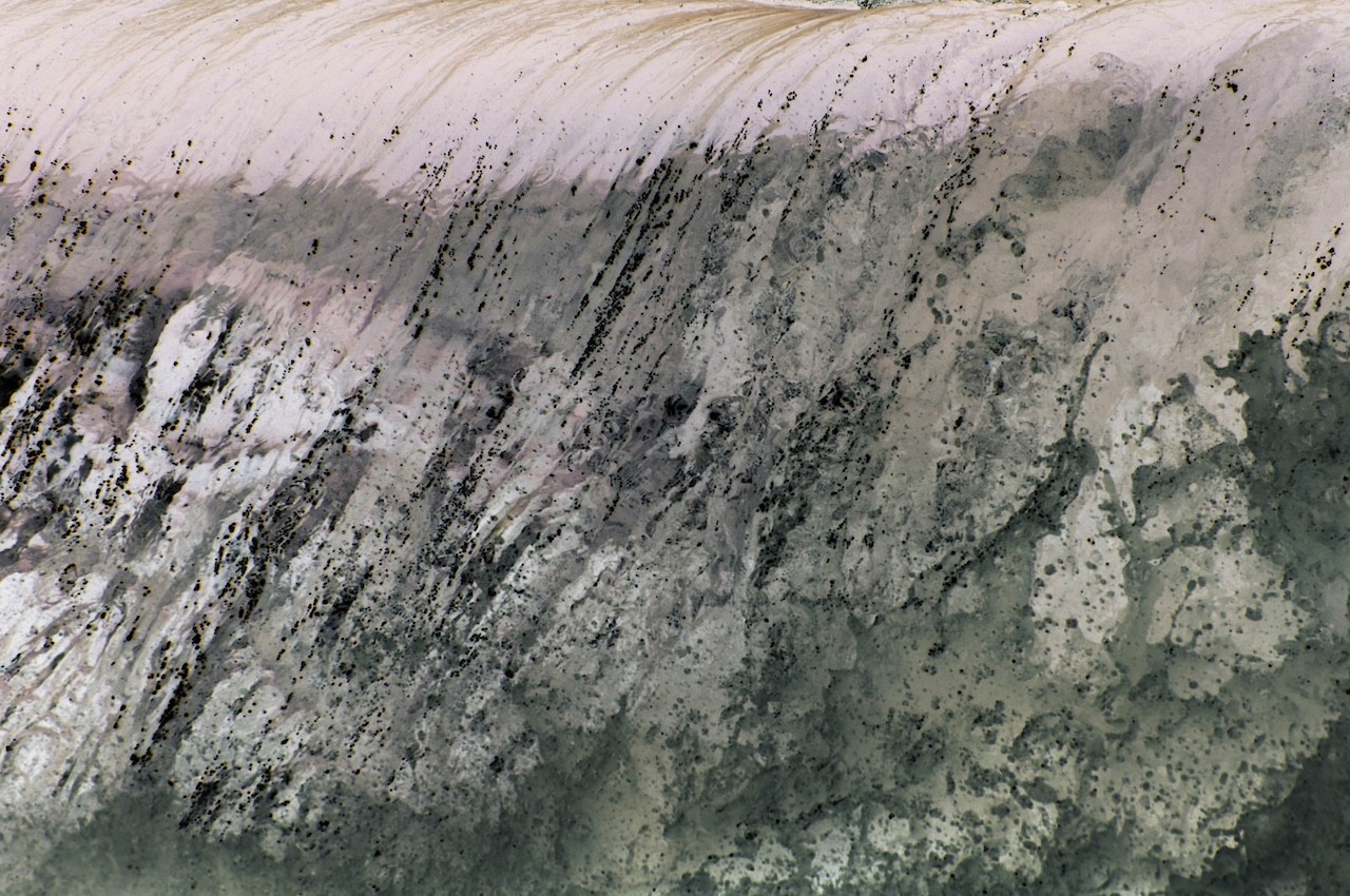 An abstract composition of layered, textured surfaces in muted earth tones.