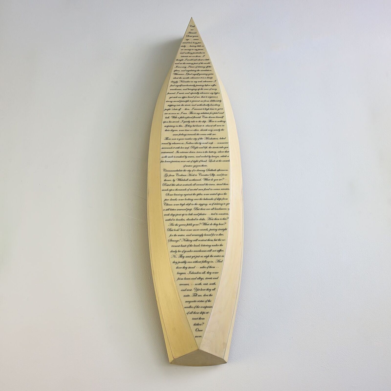 A minimalist wall art piece featuring a boat-shaped frame filled with dense text.