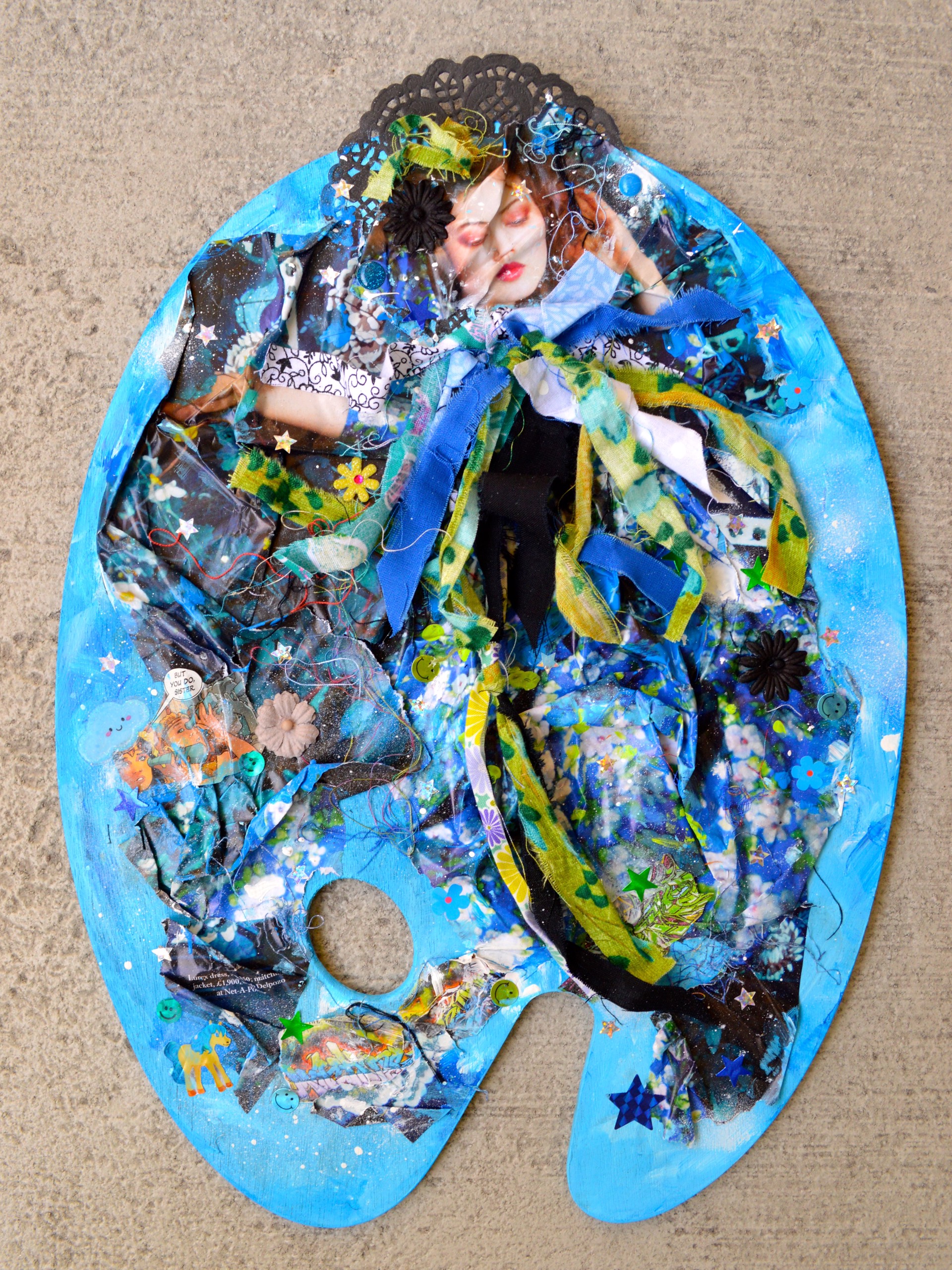 A collage of a woman's face on a blue plate.