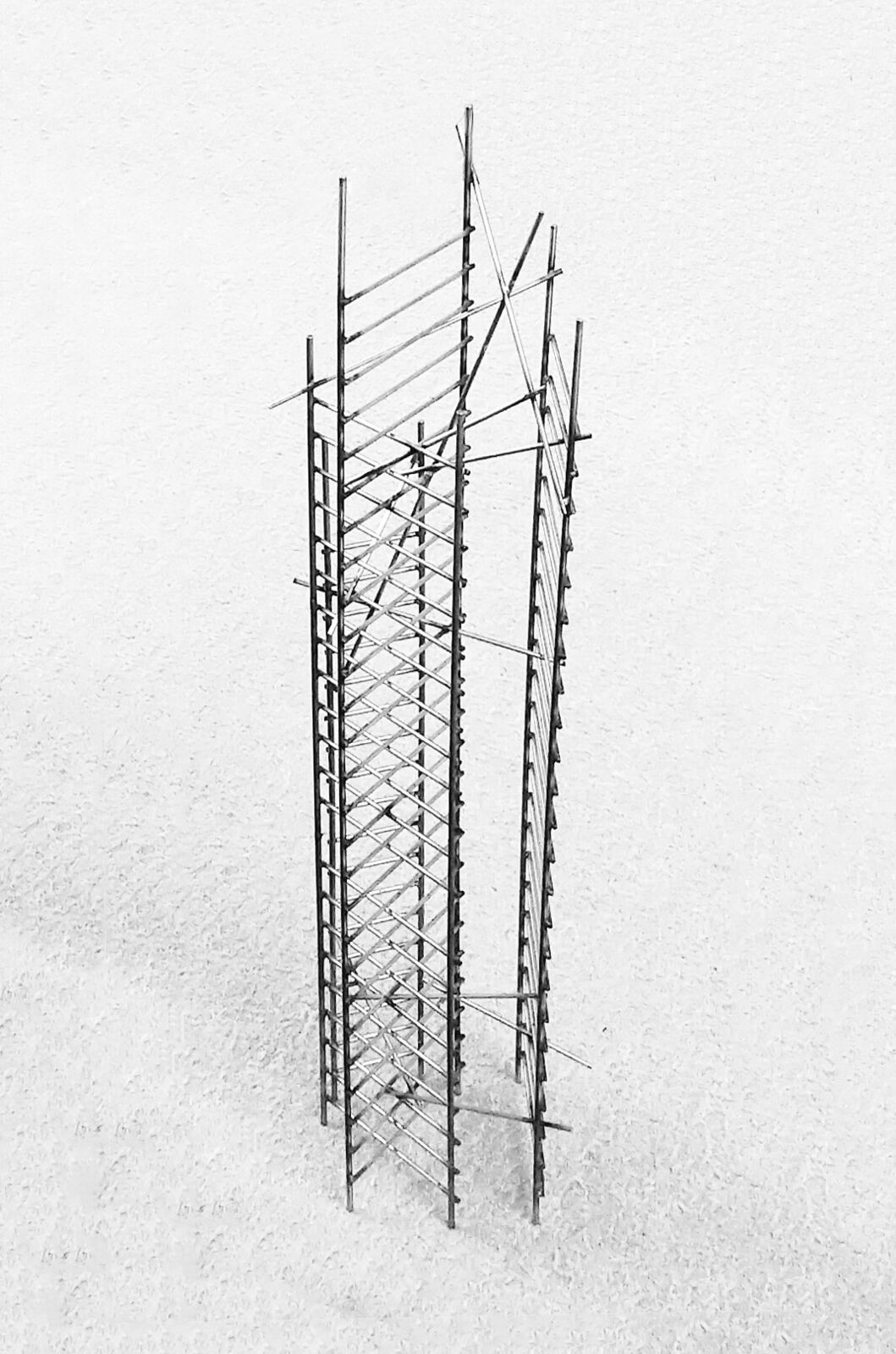 A black and white photo of a tall metal structure.