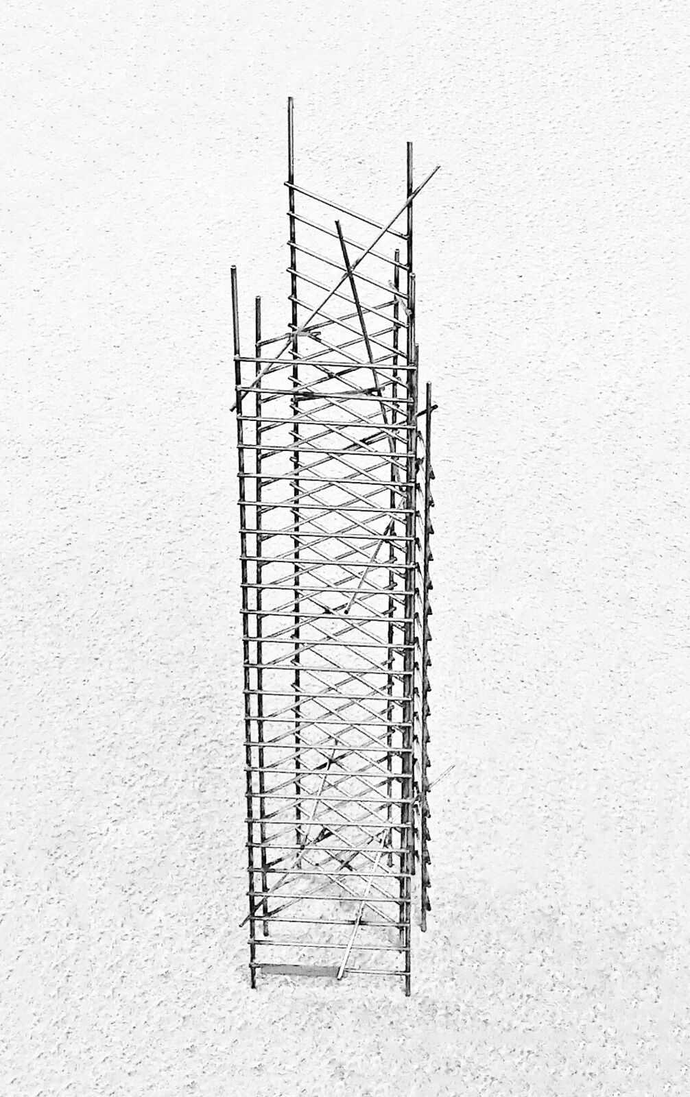 A black and white photo of a tall metal structure.