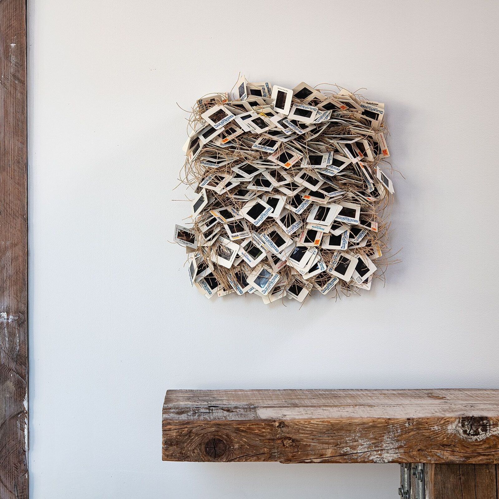 A chaotic pile of vintage slide frames tangled with twine.