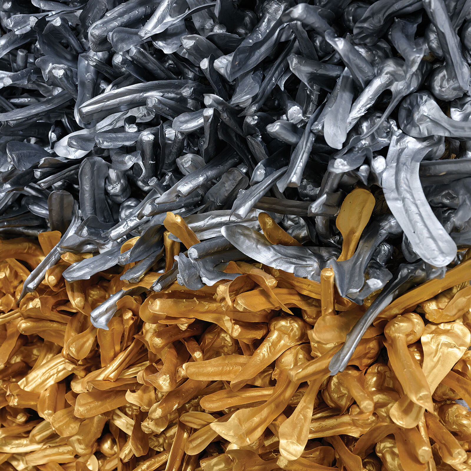 A textured square artwork composed of two distinct metallic sections, one silver and one gold.