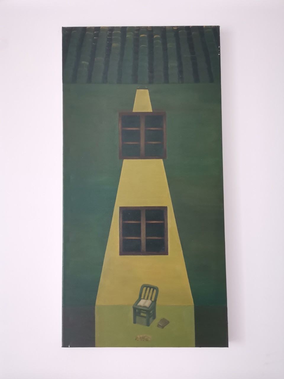 A surreal painting of a yellow house with two windows, a chair, and a book on a green background.