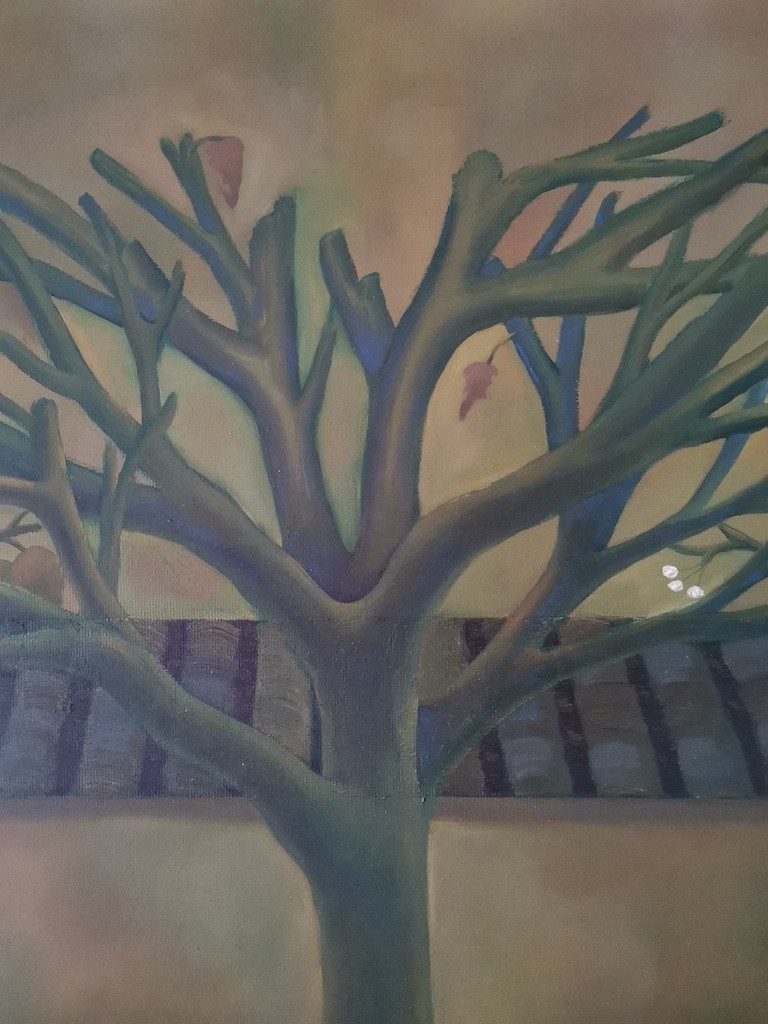 "A vertical painting of a leafless tree against a muted yellow wall with a dark tiled roof above."