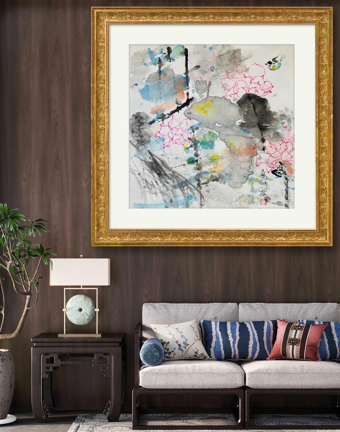 An elegant interior scene featuring a traditional-style sofa, a decorative lamp, and an ornate gold-framed artwork.