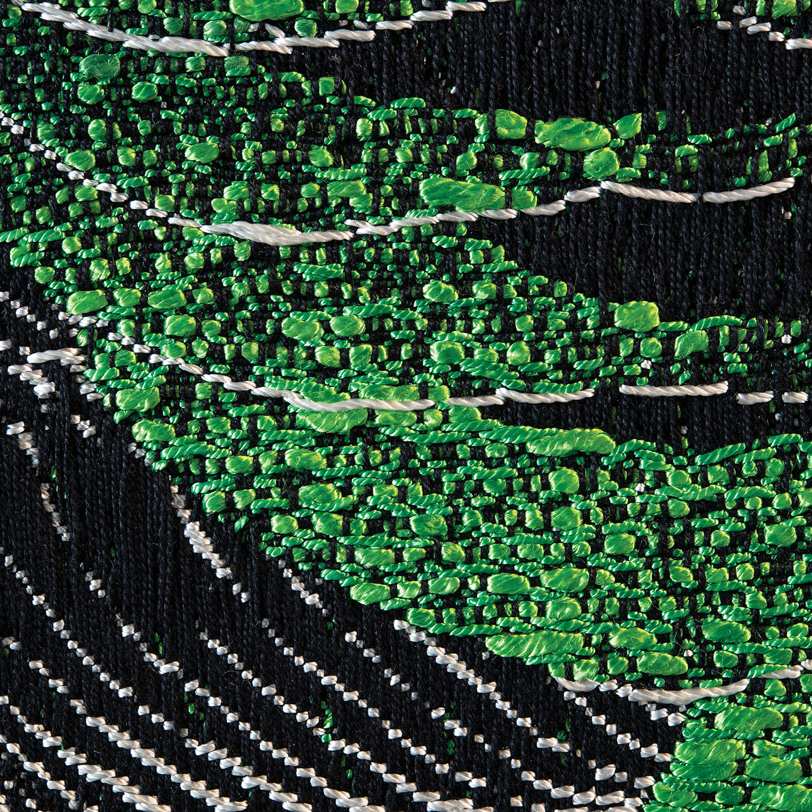 A framed textile artwork featuring a vibrant green and black abstract pattern.
