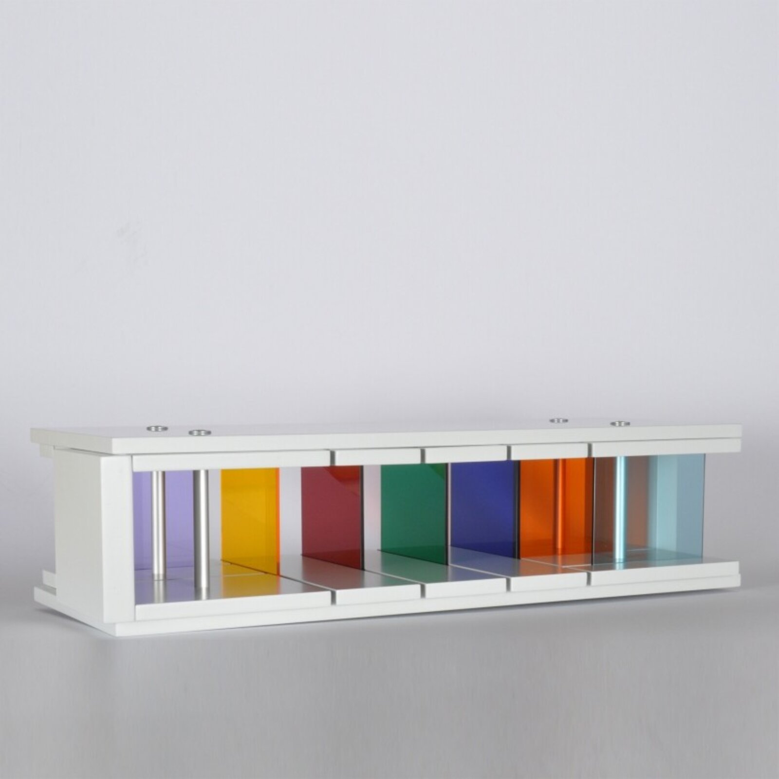 A sleek white console table featuring a row of colorful translucent panels.