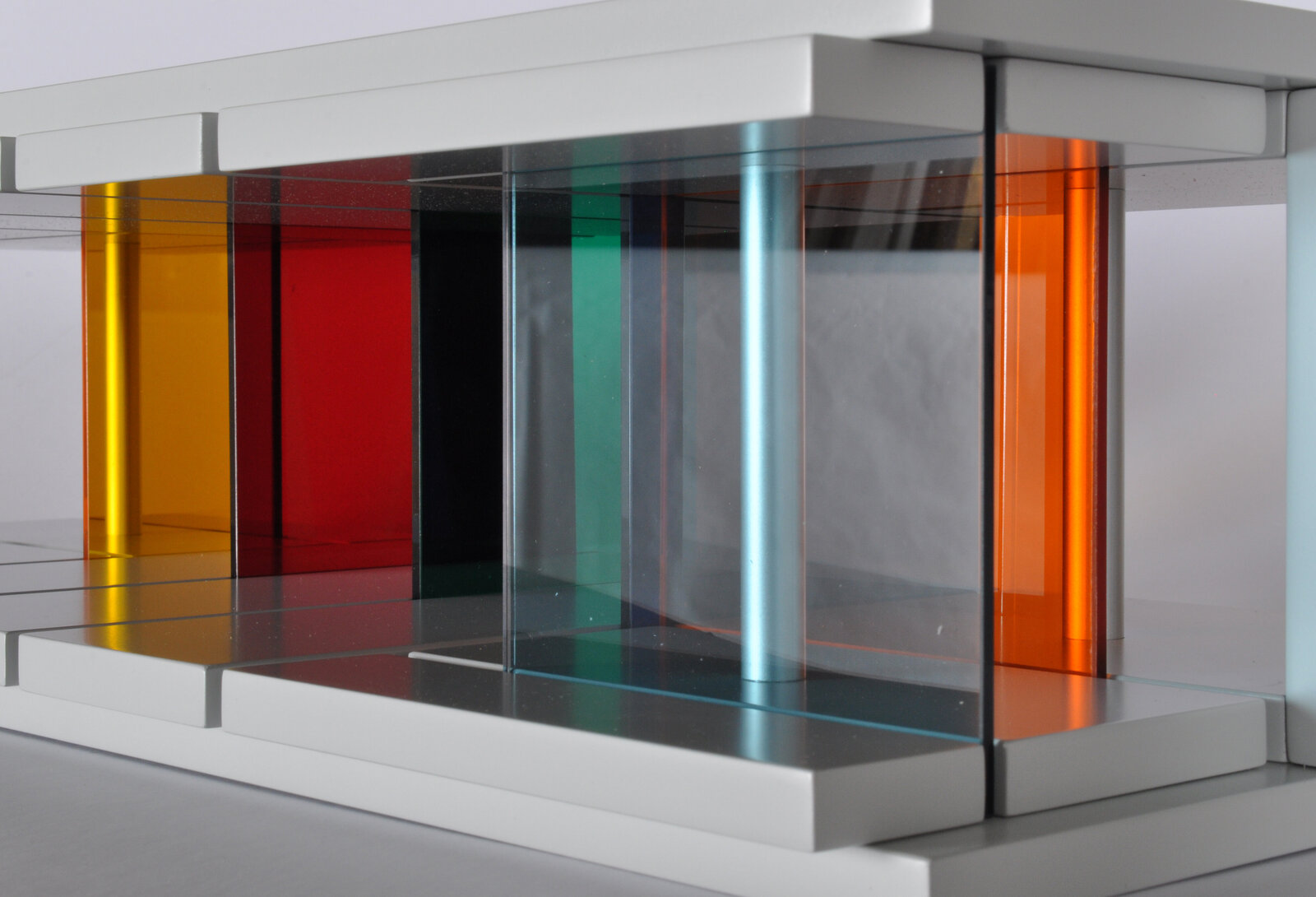 A sleek white console table featuring a row of colorful translucent panels.