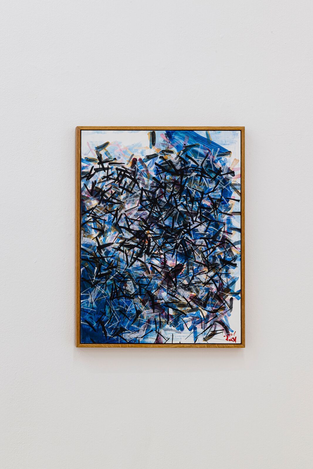 A dynamic abstract painting featuring chaotic black strokes over a vibrant blue background.