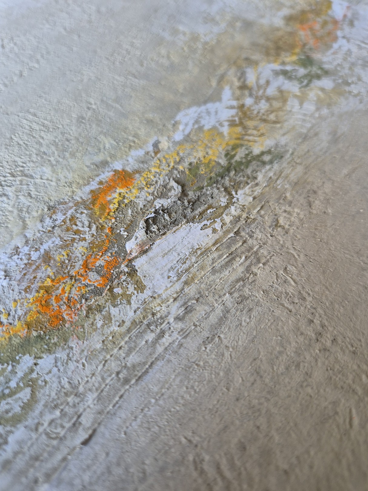 A textured abstract painting featuring a horizontal band of warm colors against a rough, neutral background.