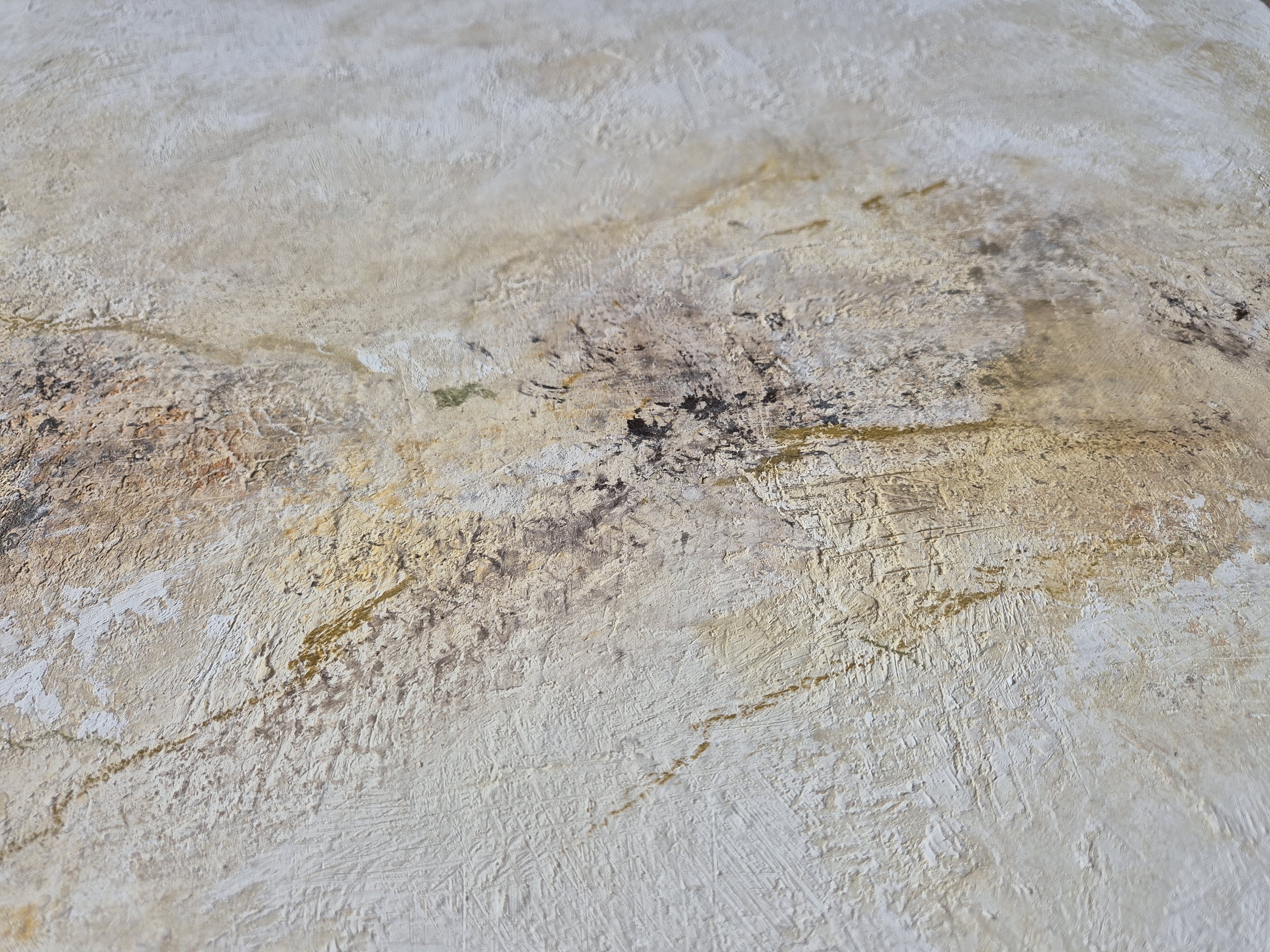 An abstract textured surface with layered, weathered tones.