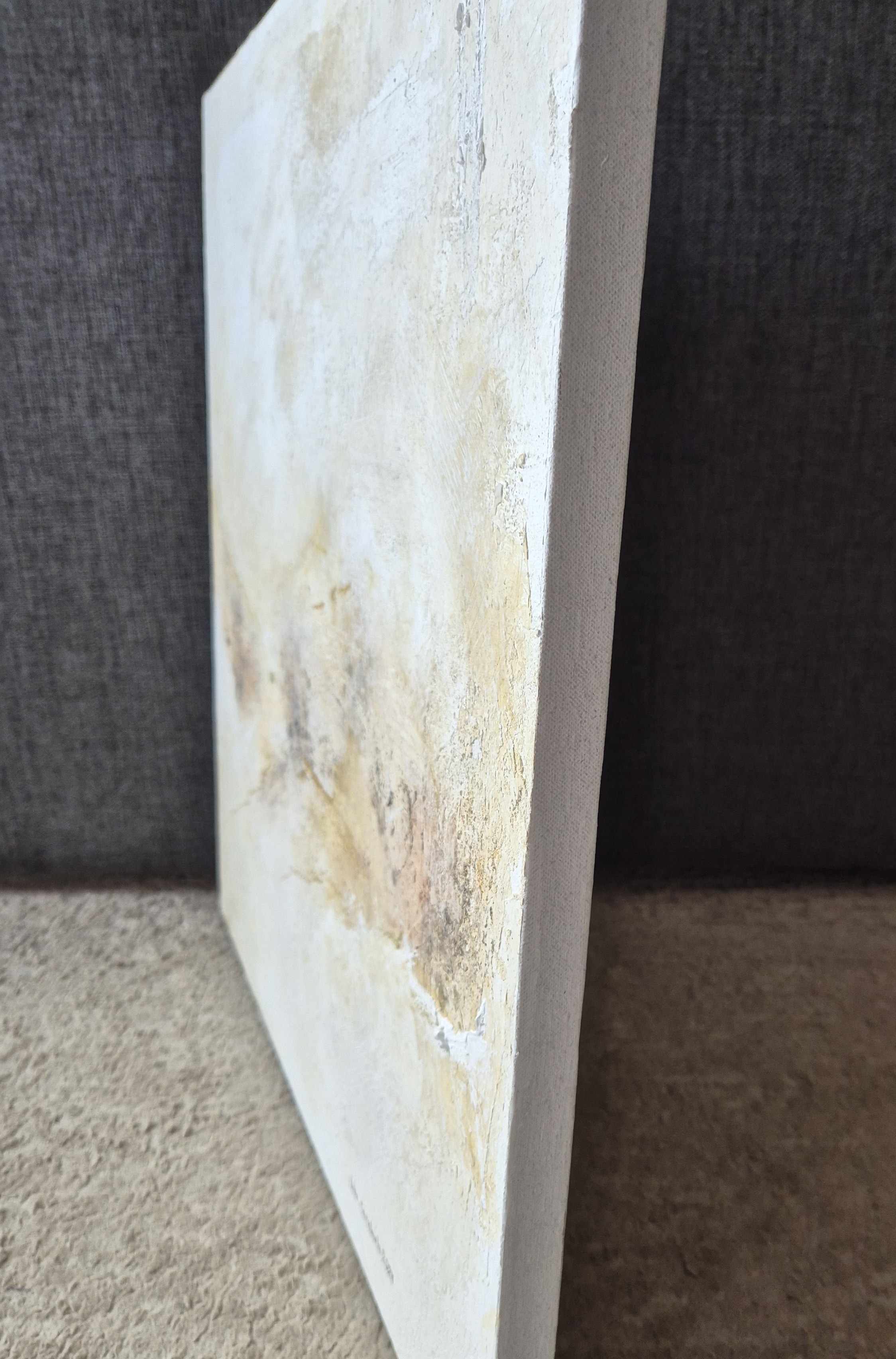 An abstract textured surface with layered, weathered tones.