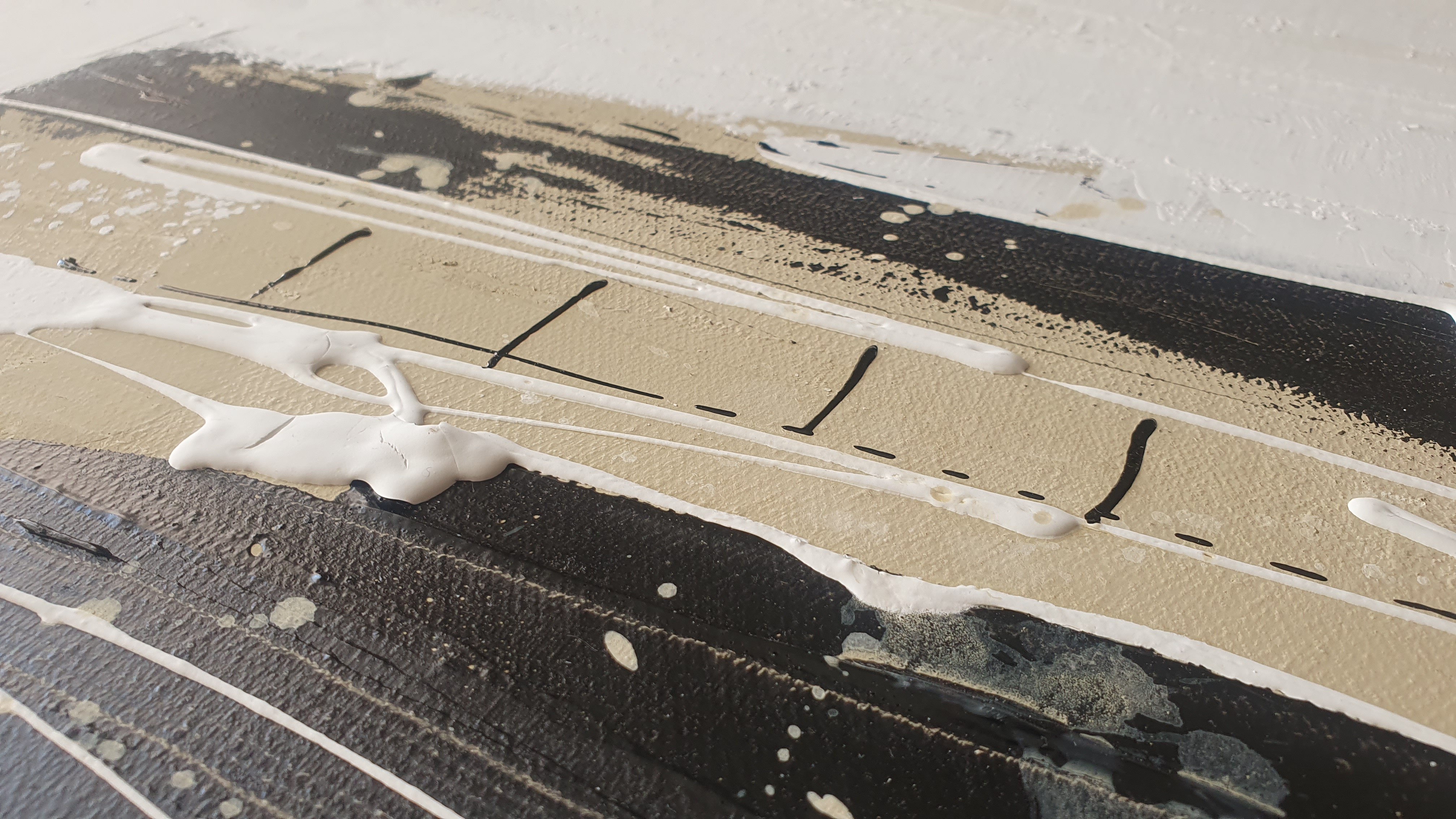 A painting with black and white paint on a white background.
