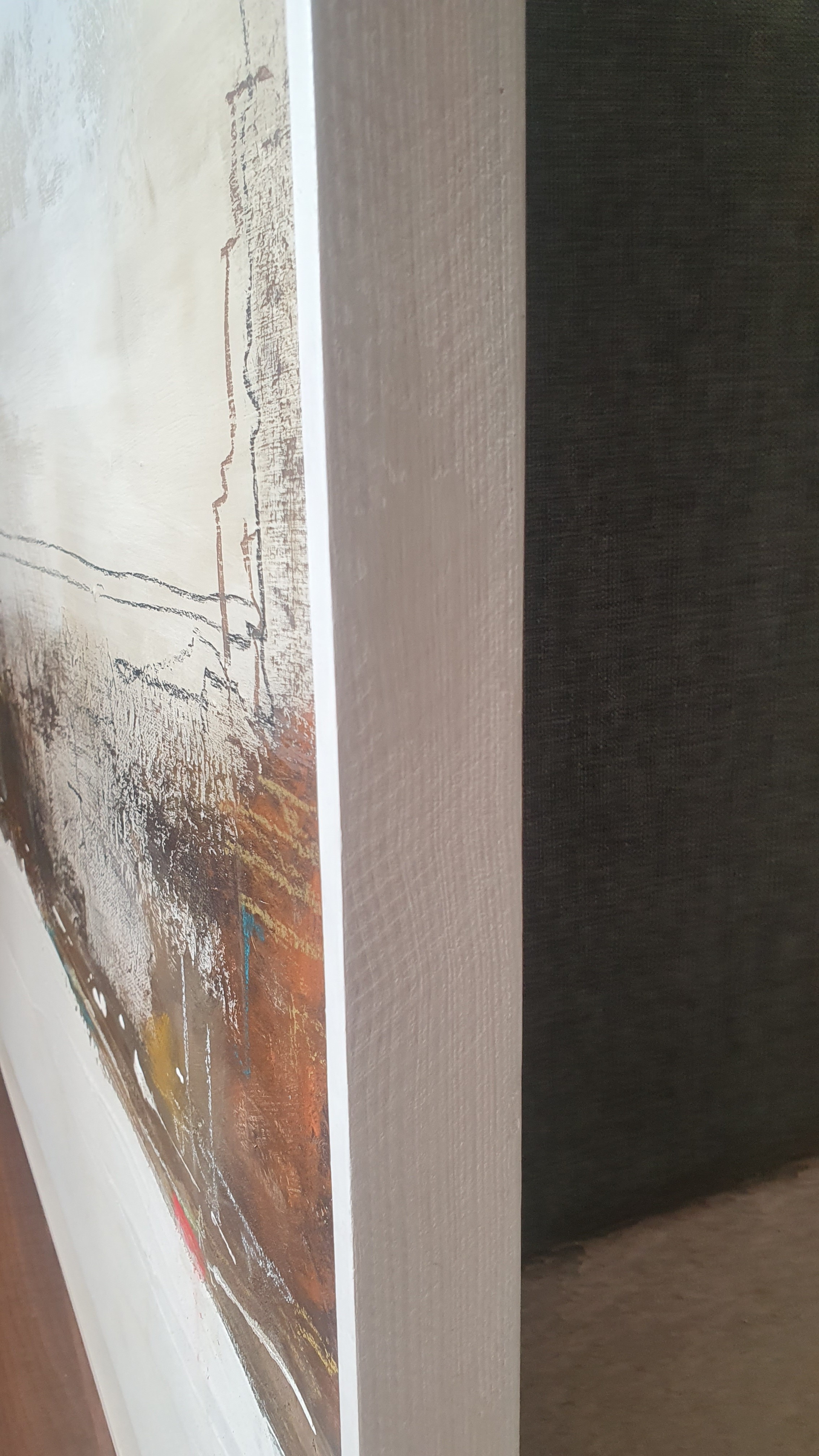 A painting of a cityscape with a white frame on a wall.