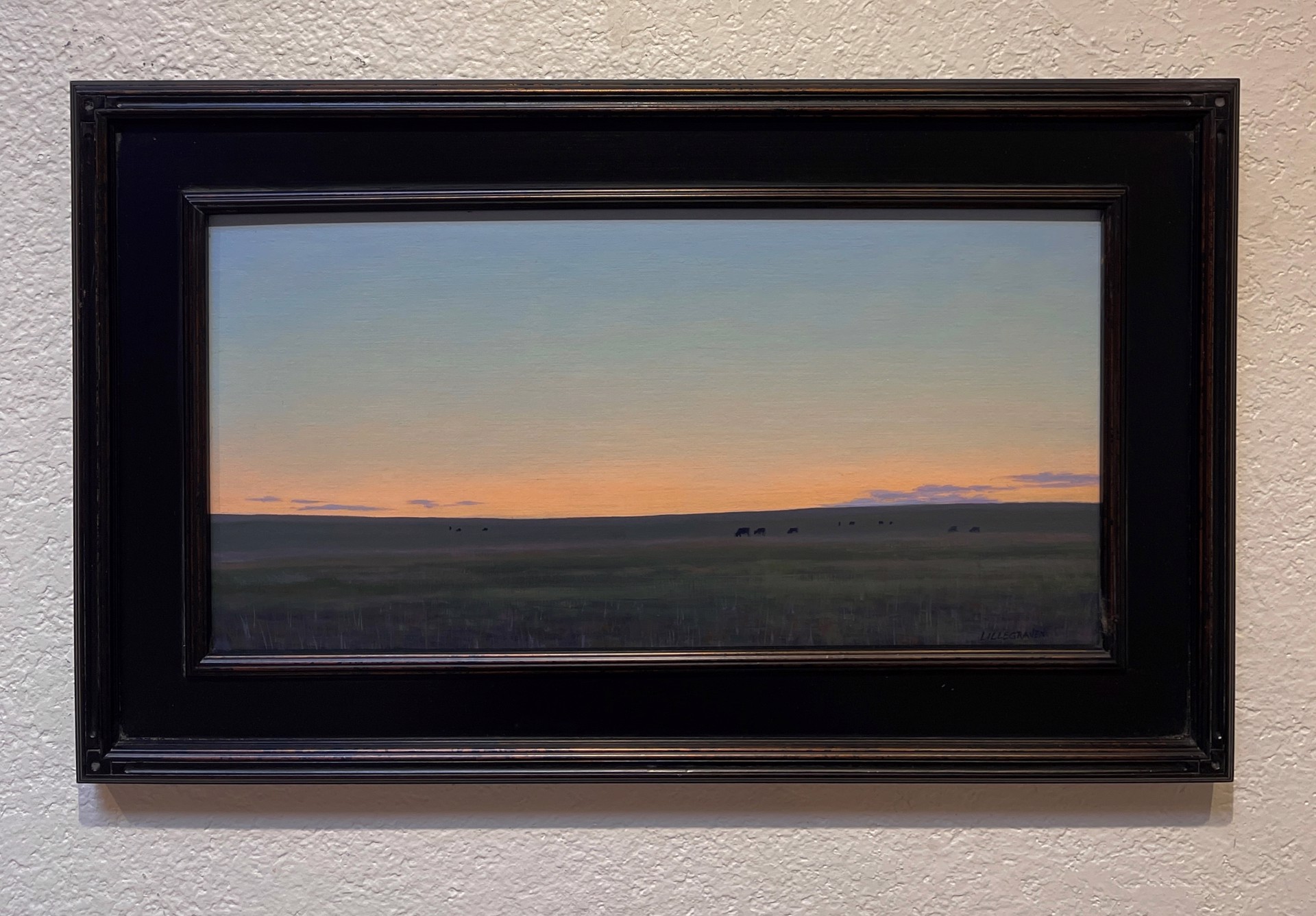 A painting of a herd of cattle grazing in a field at sunset.