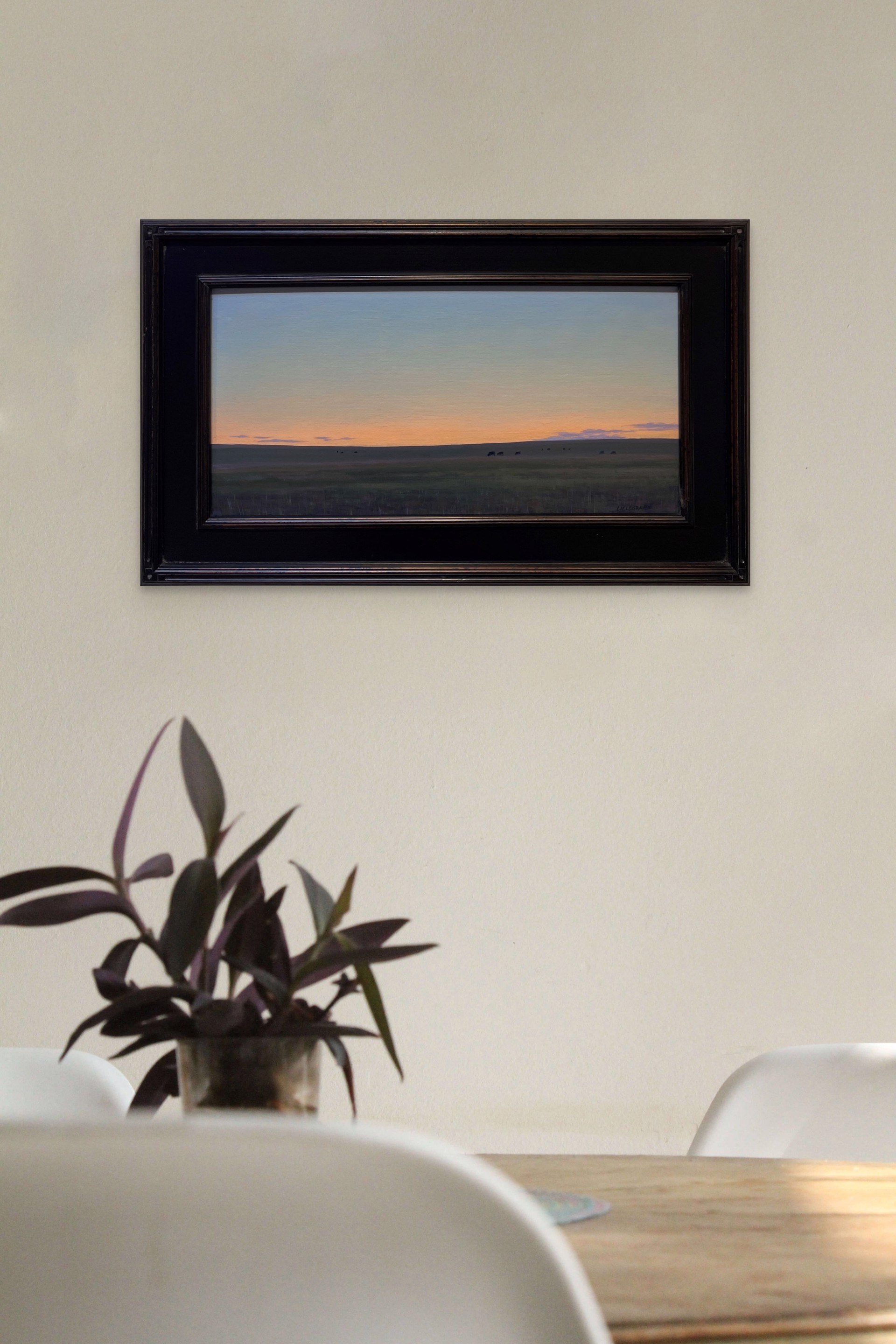 A painting of a herd of cattle grazing in a field at sunset.