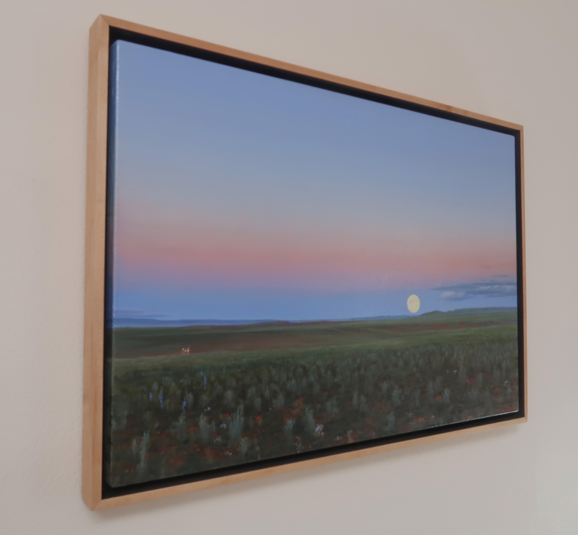 A painting of a field with a full moon in the sky.
