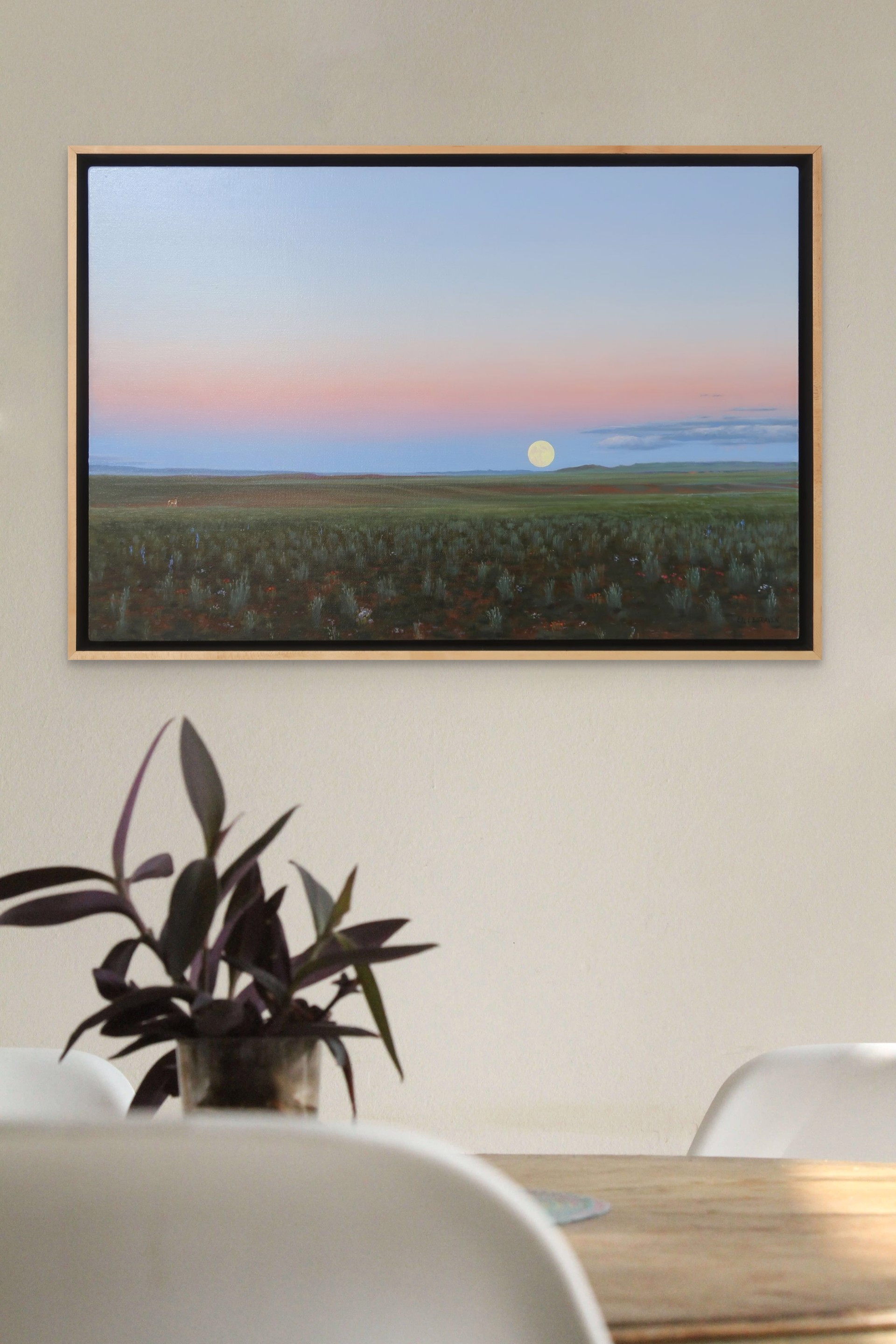 A painting of a field with a full moon in the sky.