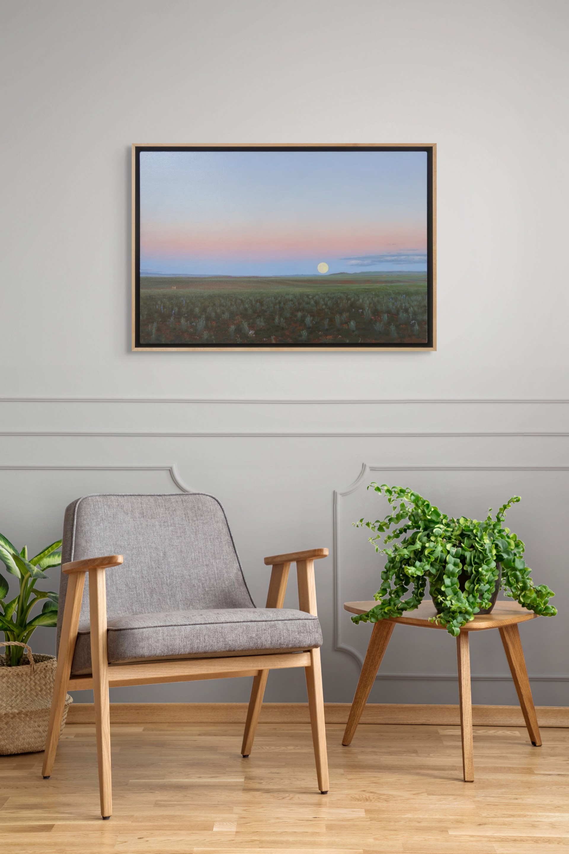A painting of a field with a full moon in the sky.