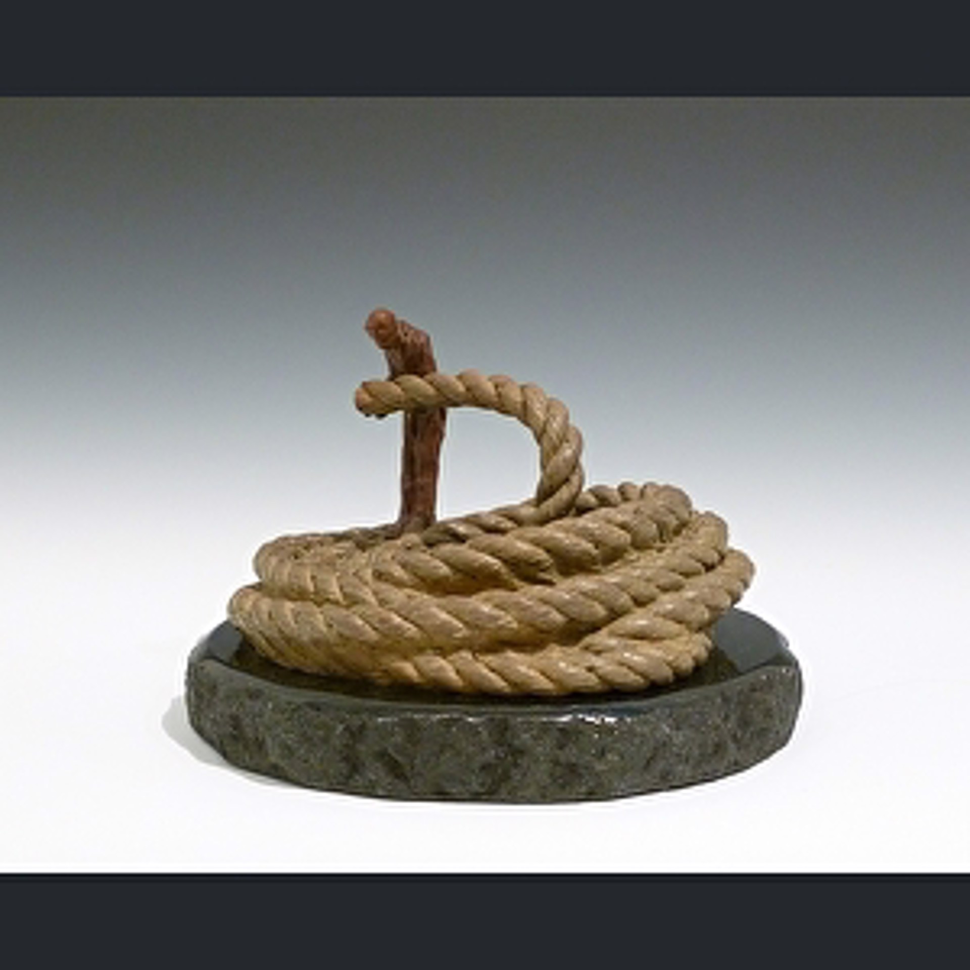 A sculpture of a man holding a rope on a stone base.