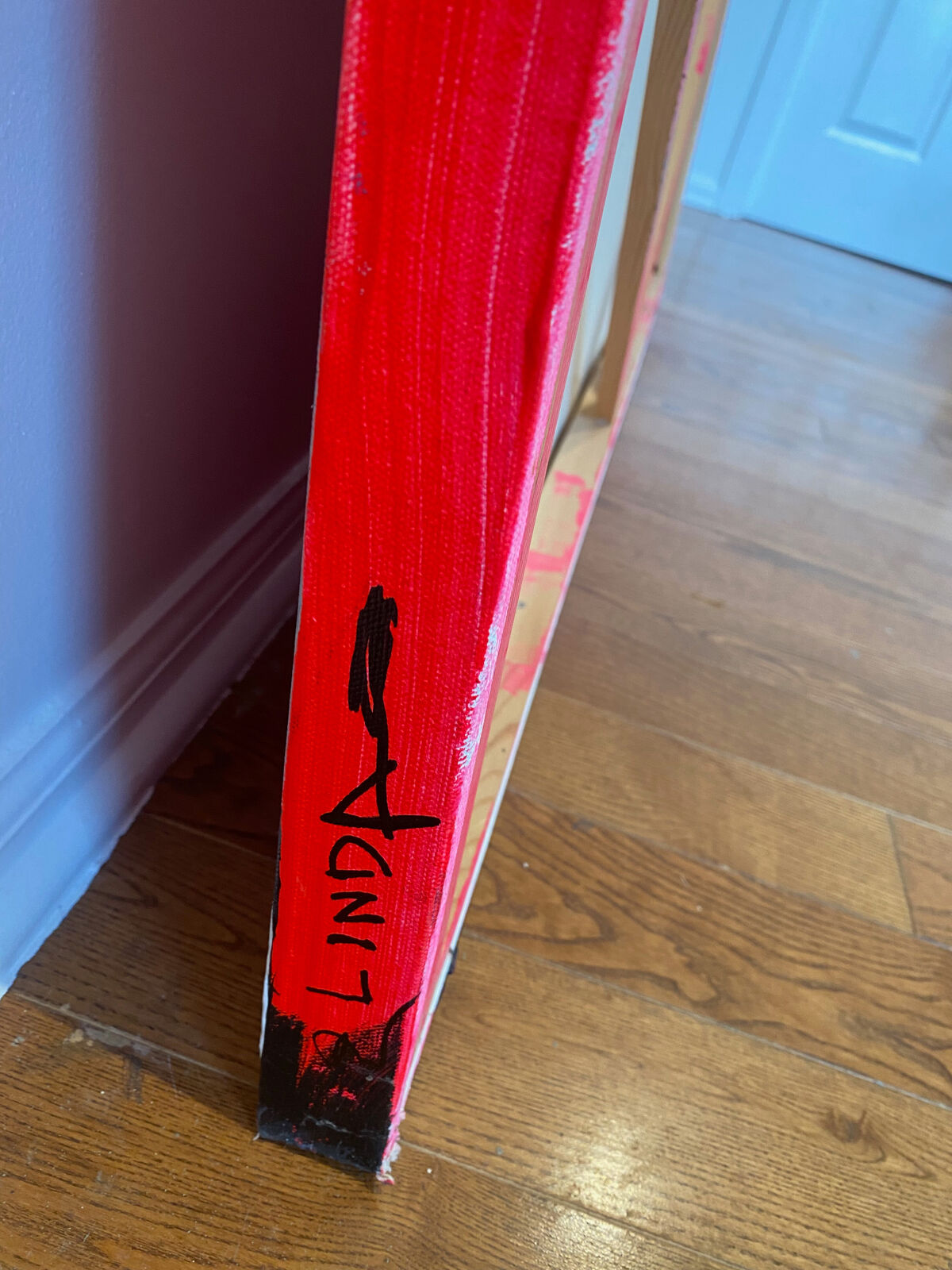 A painting of a cityscape with pink and black paint on it.