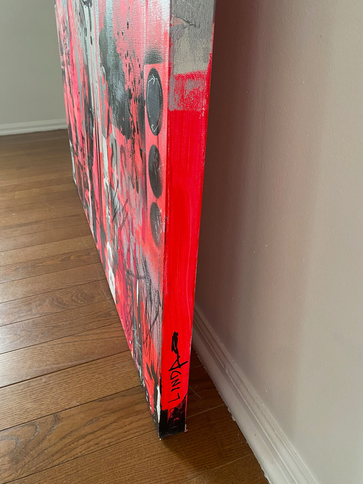 A painting of a cityscape with pink and black paint on it.