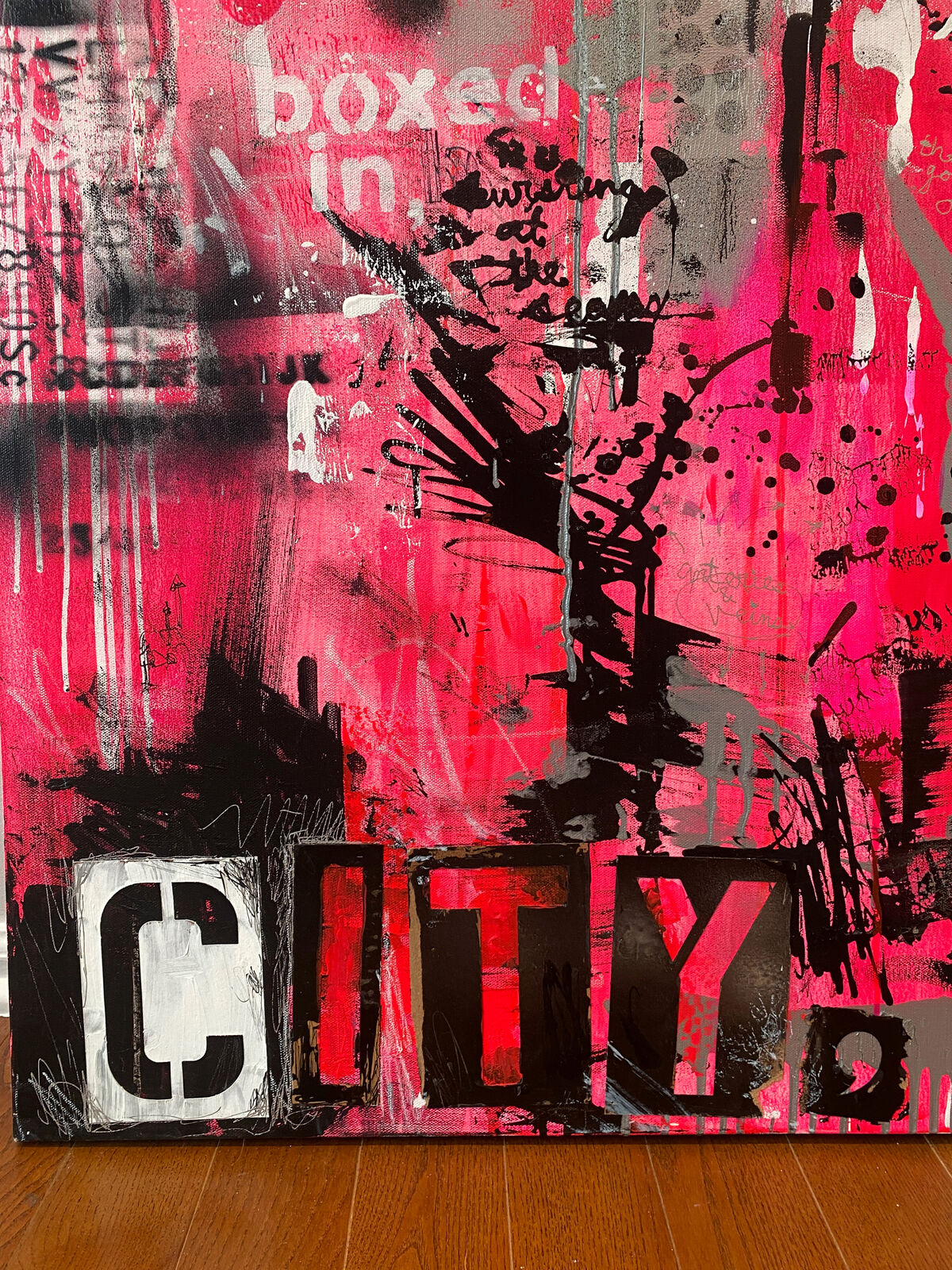 A painting of a cityscape with pink and black paint on it.