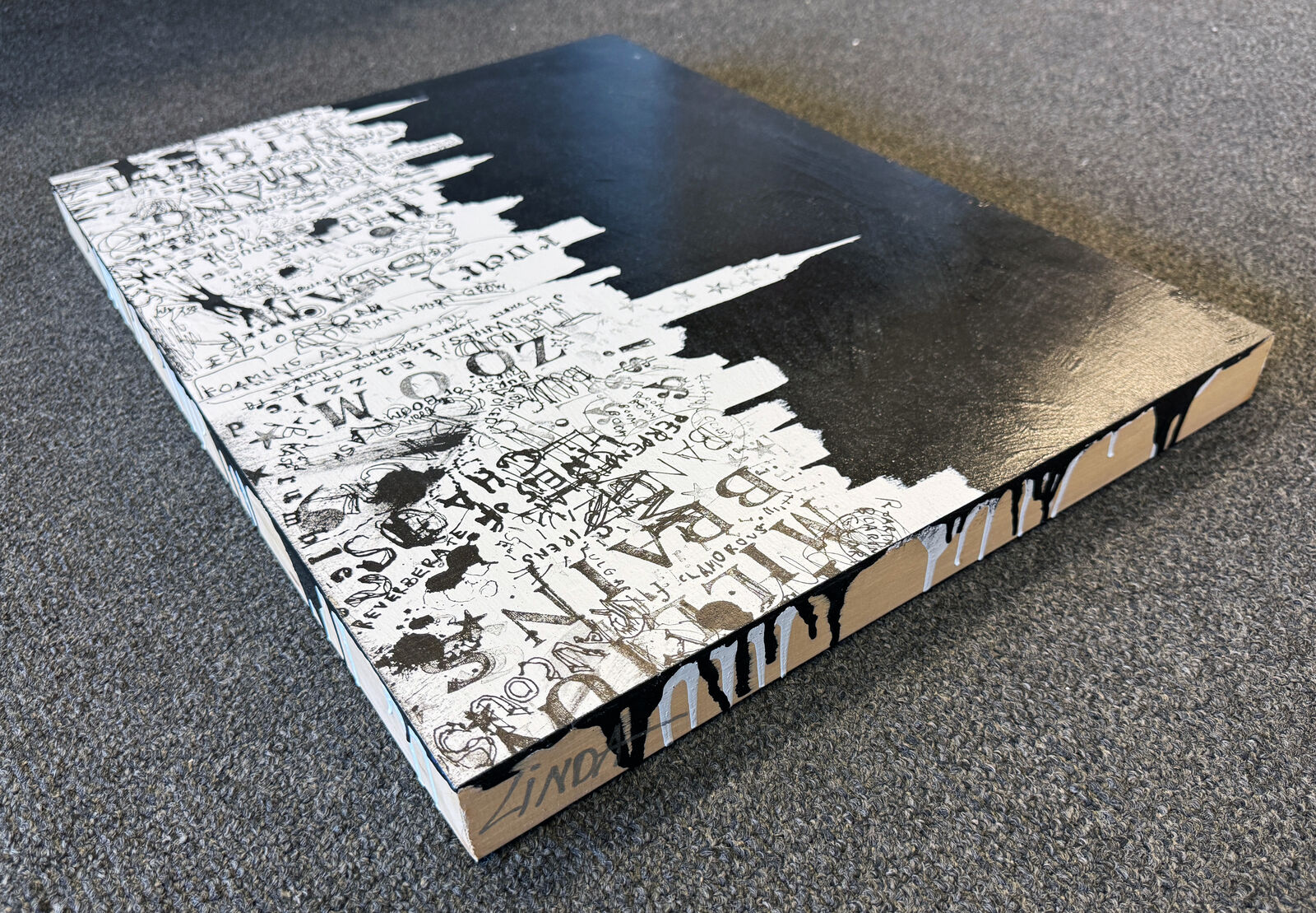 A black and white painting of a city skyline.