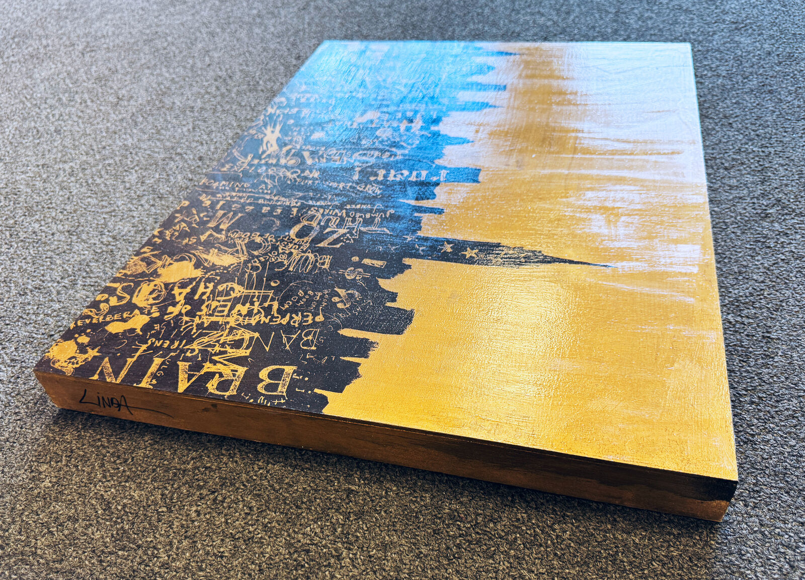 A painting of a city skyline on a yellow background.