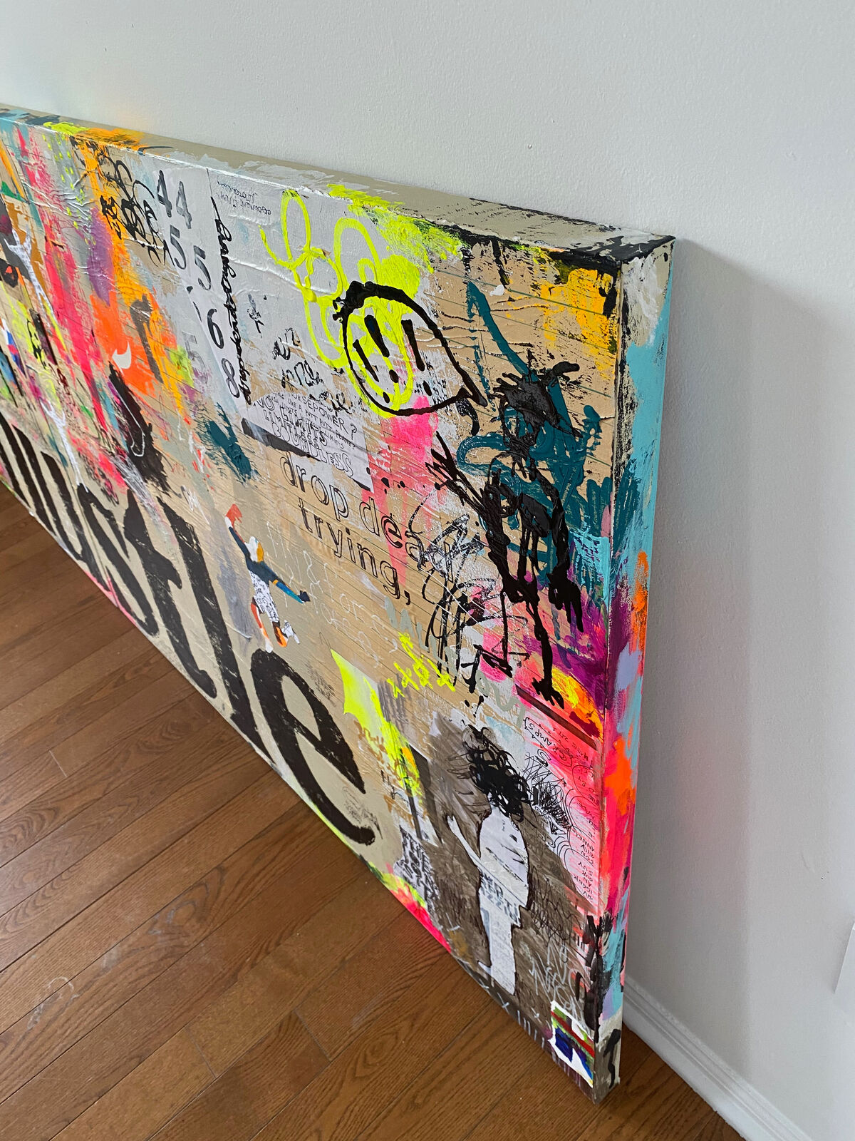 A collage of the word hustle on a wall covered in graffiti.