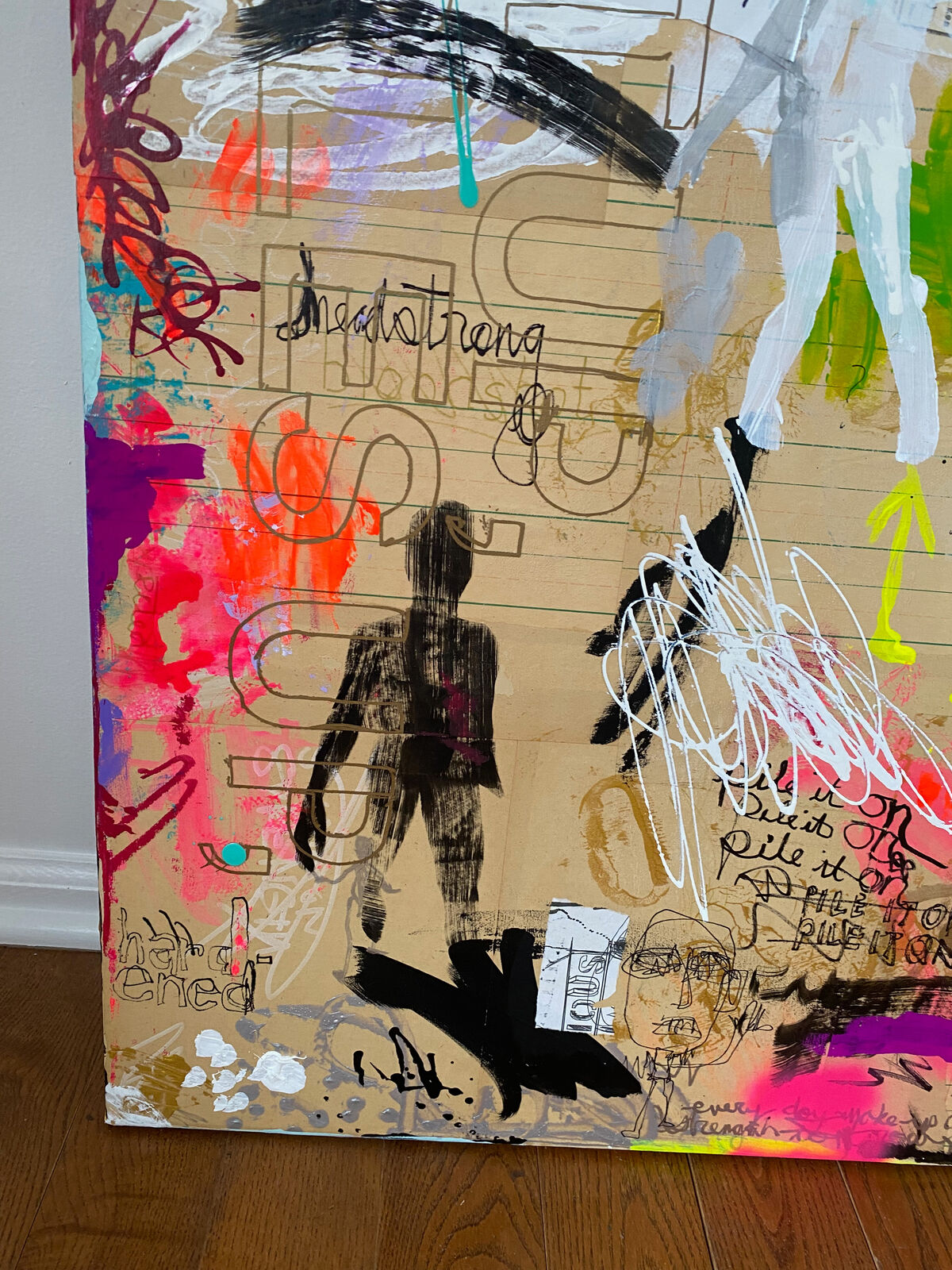 A painting with the word STRONG written on it. 