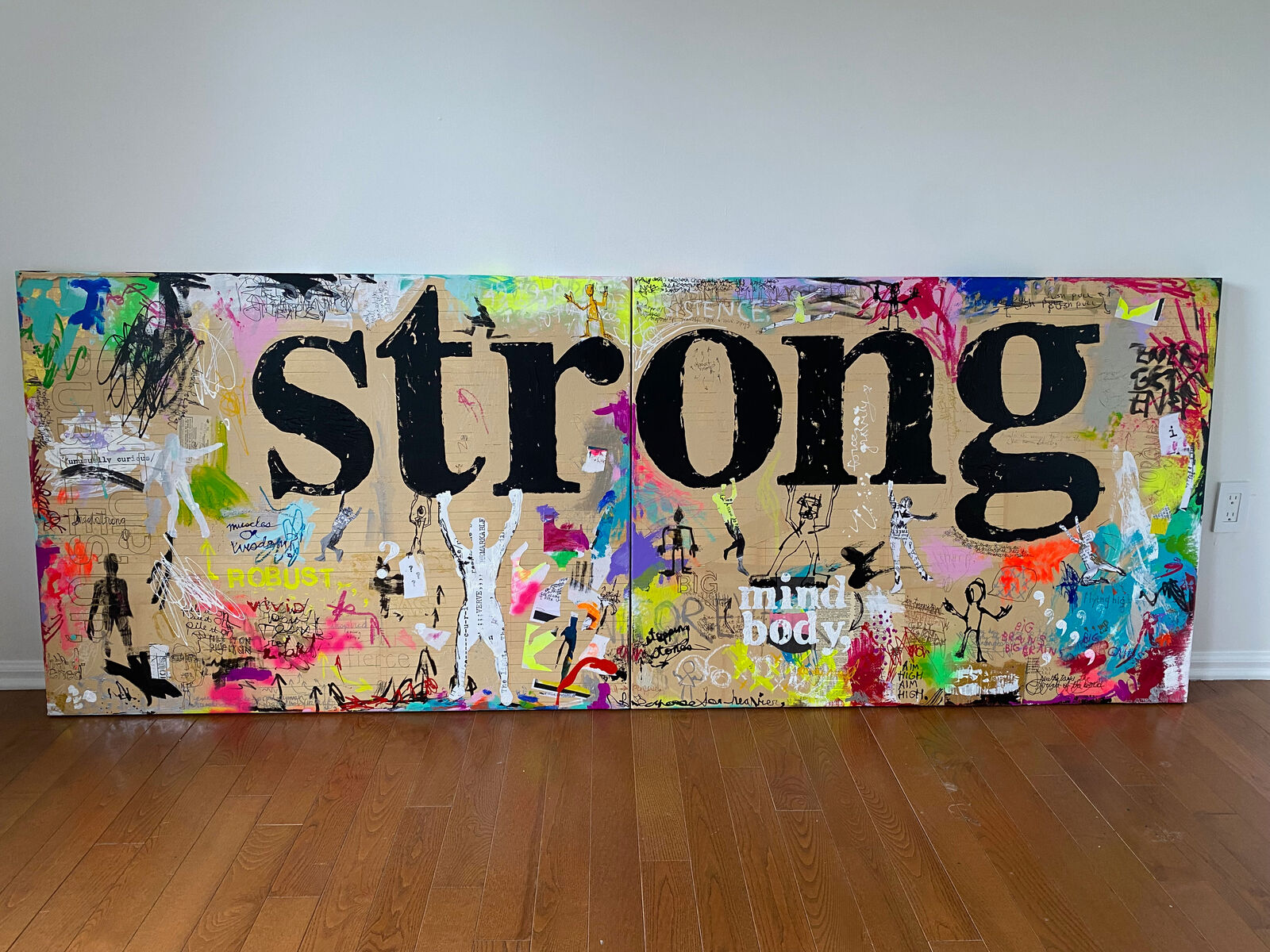 A painting with the word STRONG written on it. 