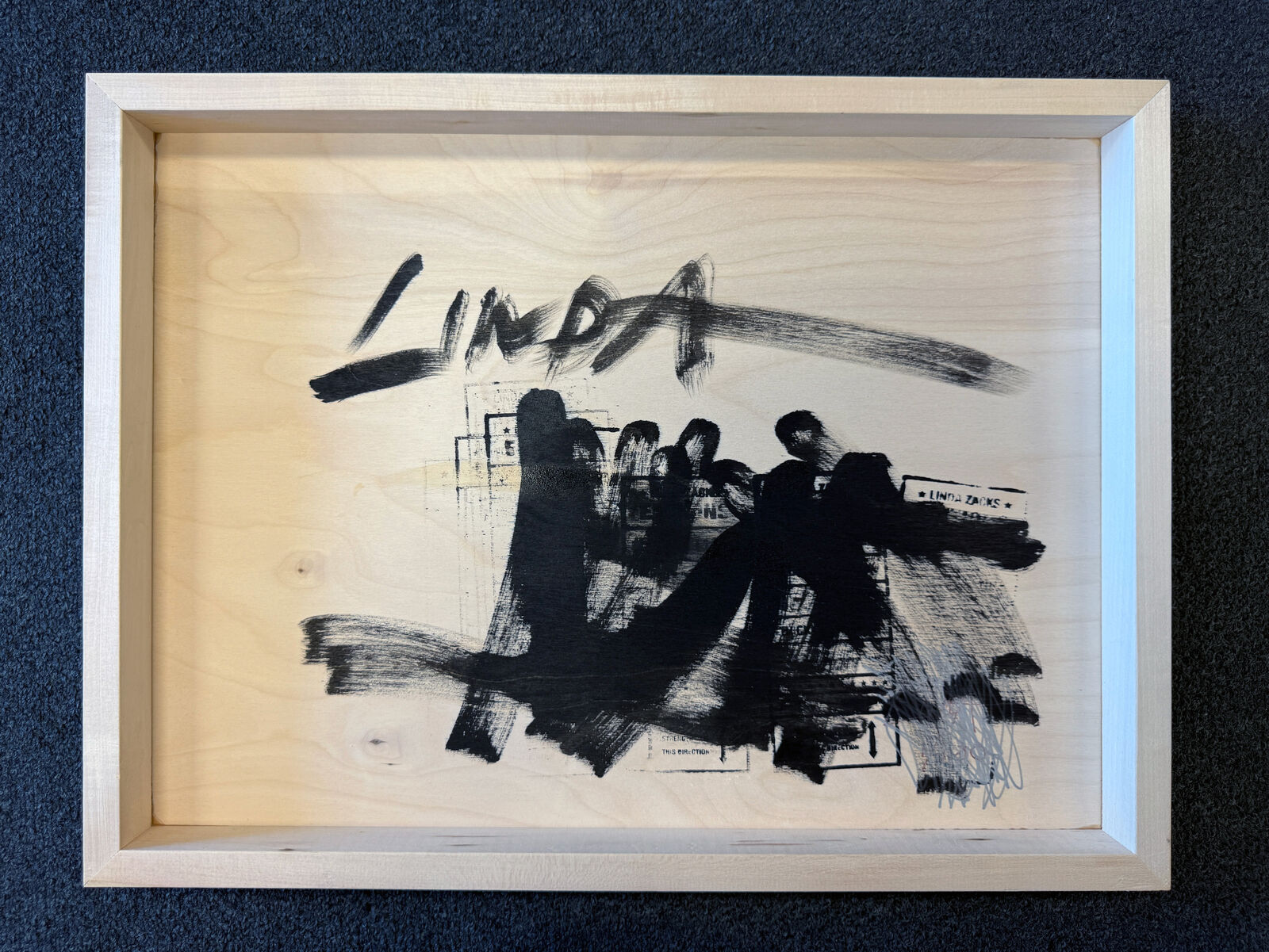 A watercolor painting of a city skyline on a wooden surface.