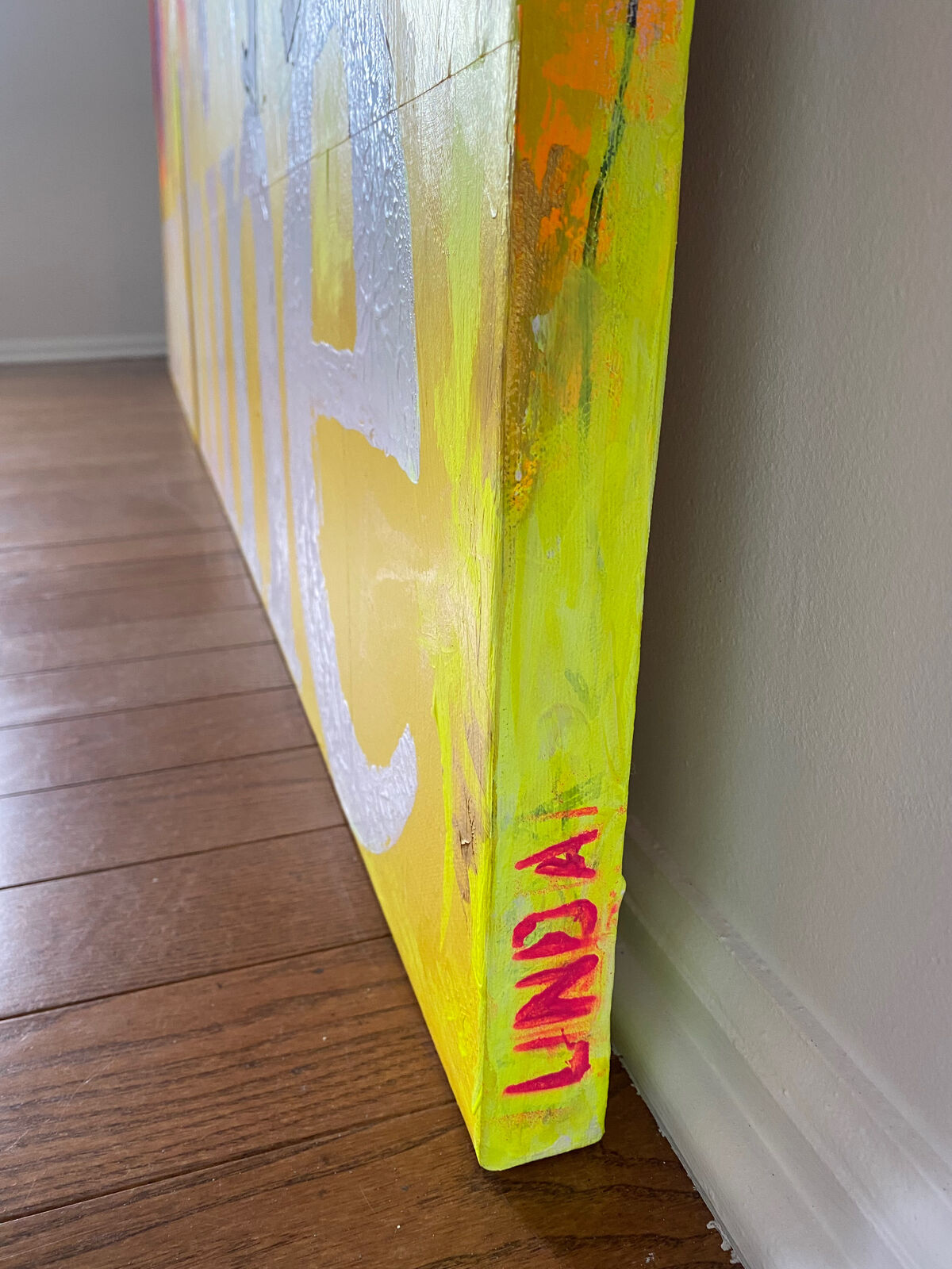 A painting of a person standing in front of a yellow background with the word sunshine painted on it.