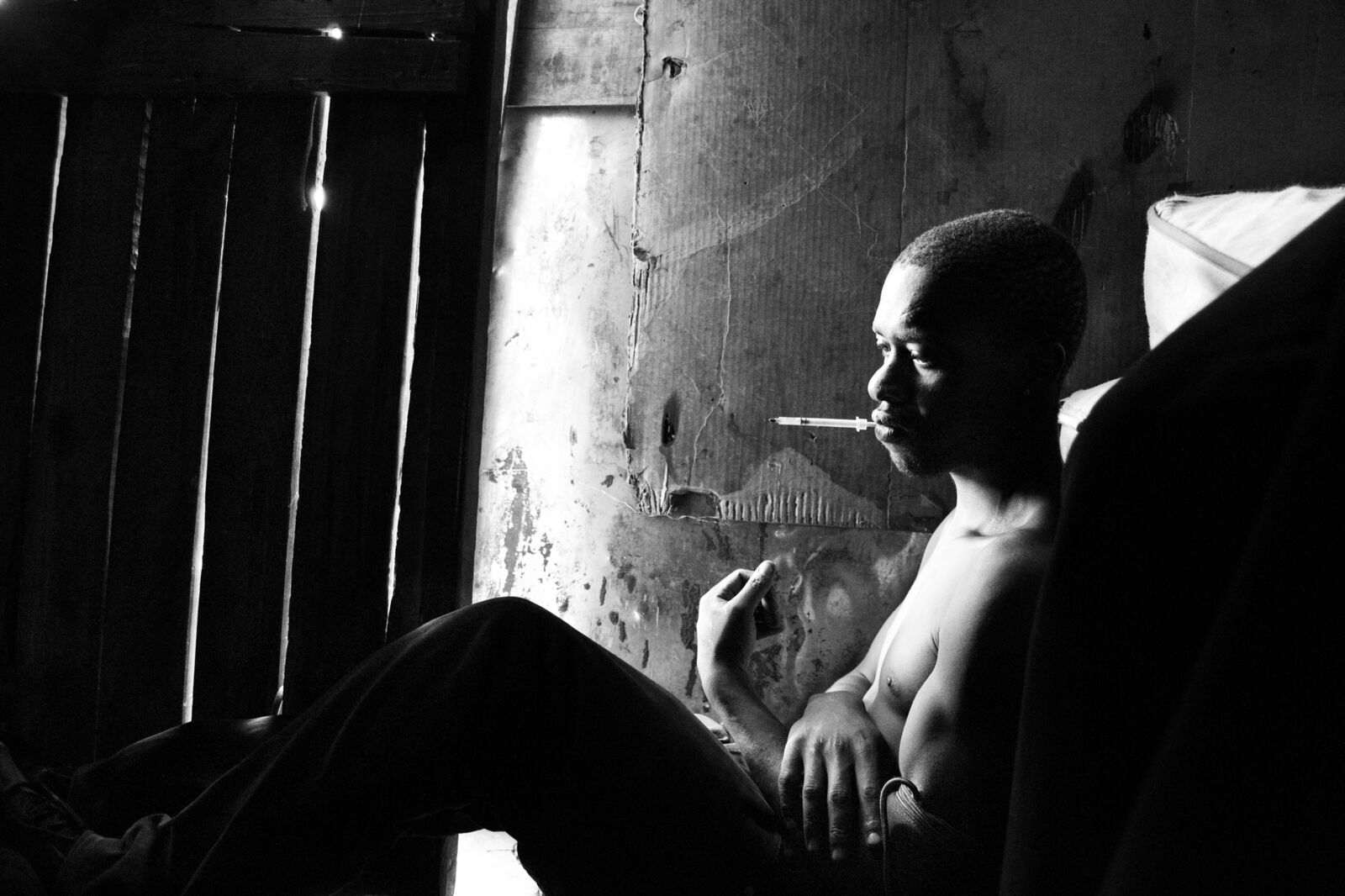 Mzwandile at home with the syringe in his mouth by Lindokuhle Sobekwa, 2013