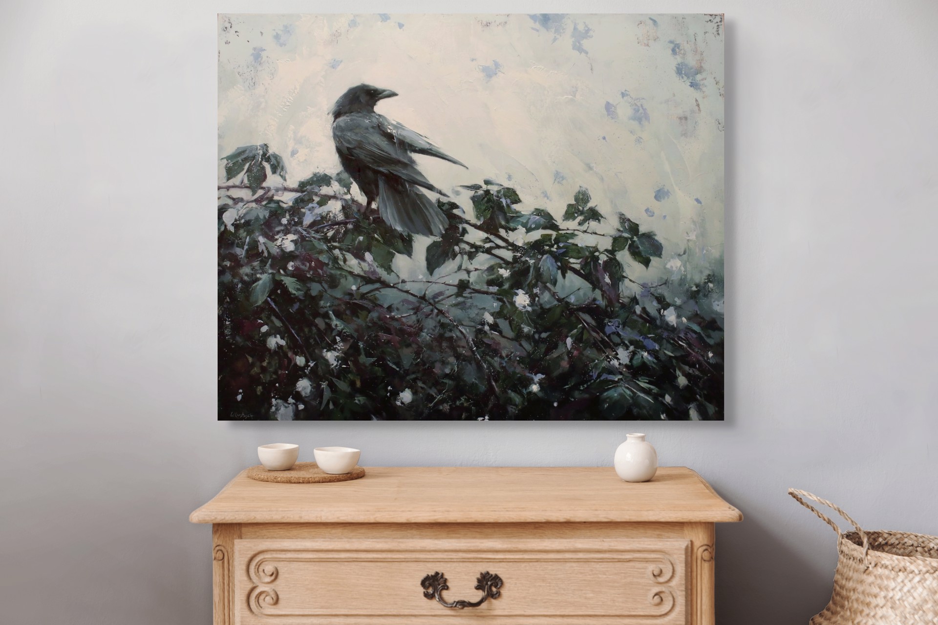 A solitary dark bird perches on a leafy branch against a textured, muted background.