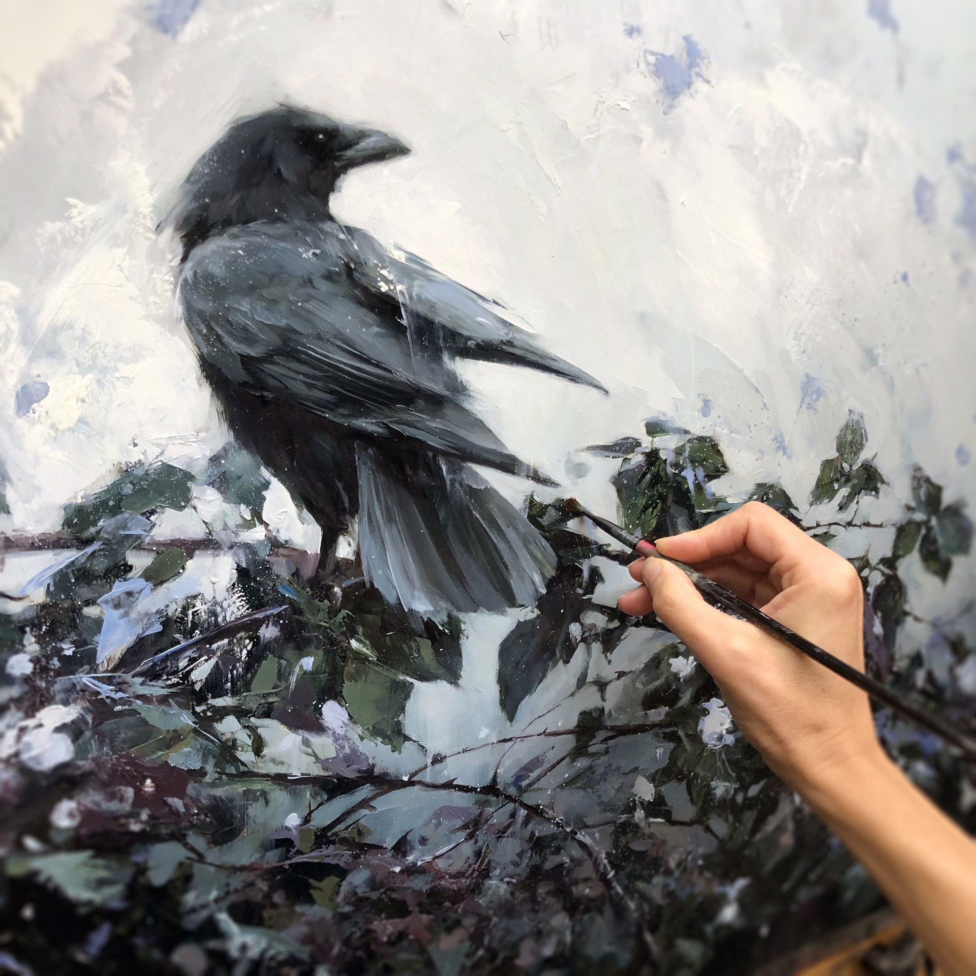 A solitary dark bird perches on a leafy branch against a textured, muted background.