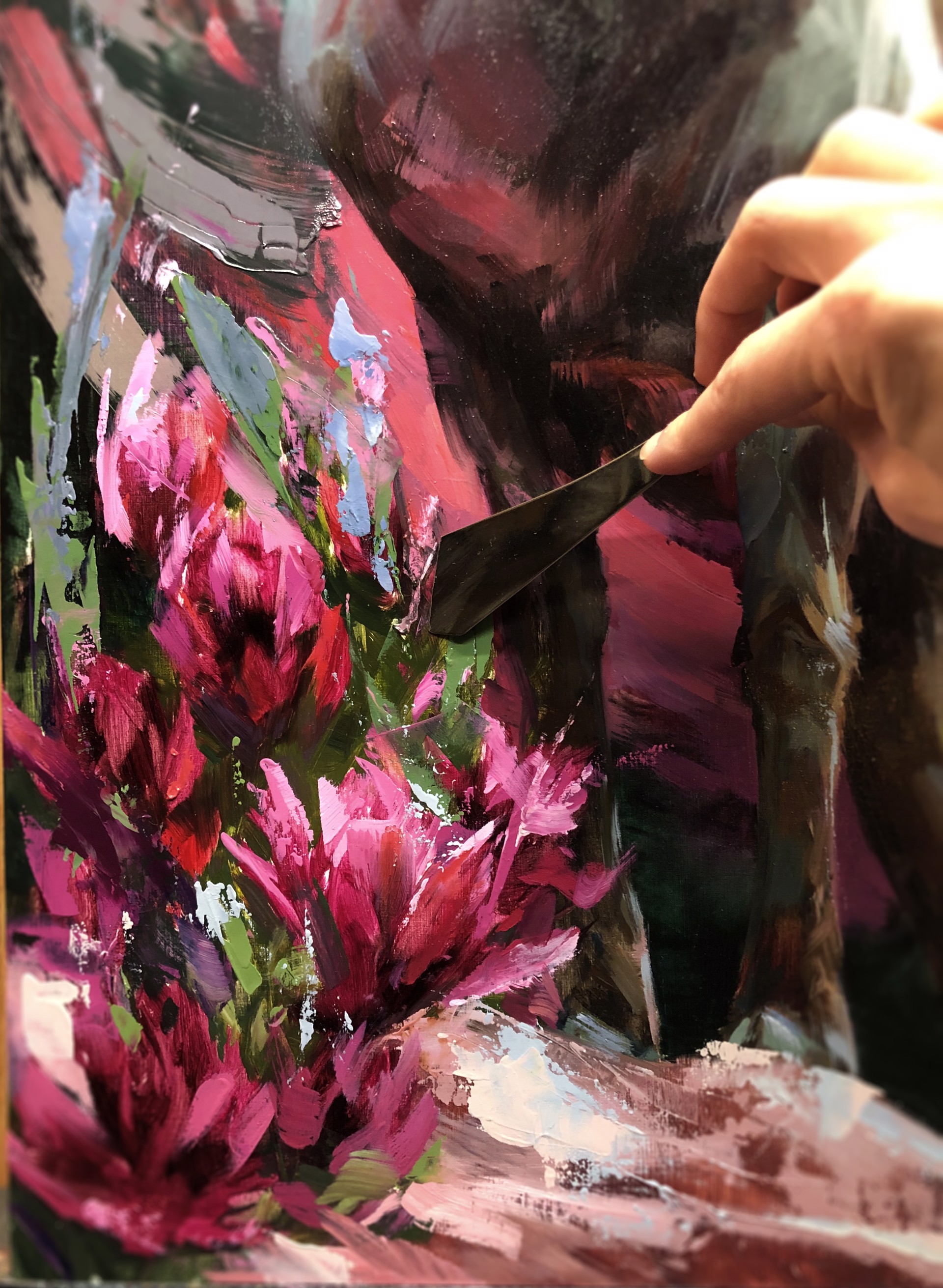 A painting of a ram standing on a rock surrounded by flowers.