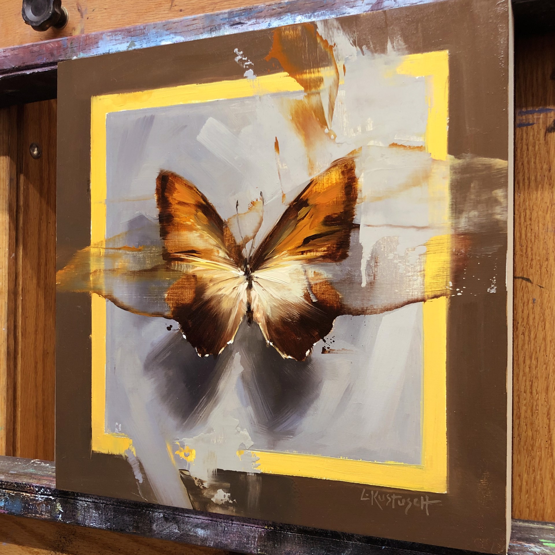 A painting of a butterfly on a brown background.