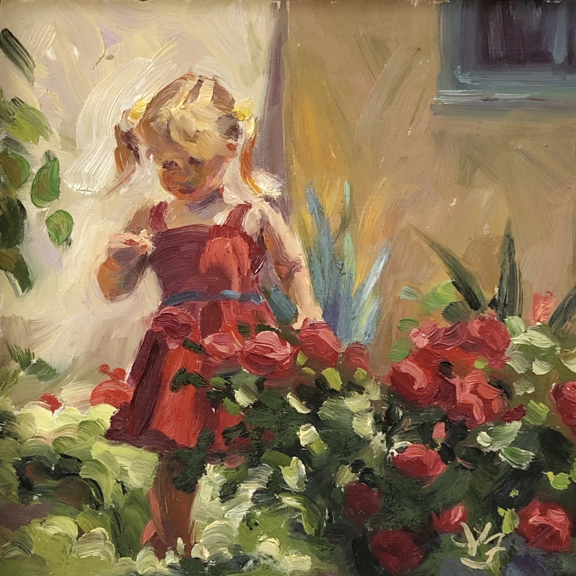 A child in a red dress stands amidst blooming roses in a sunlit garden.