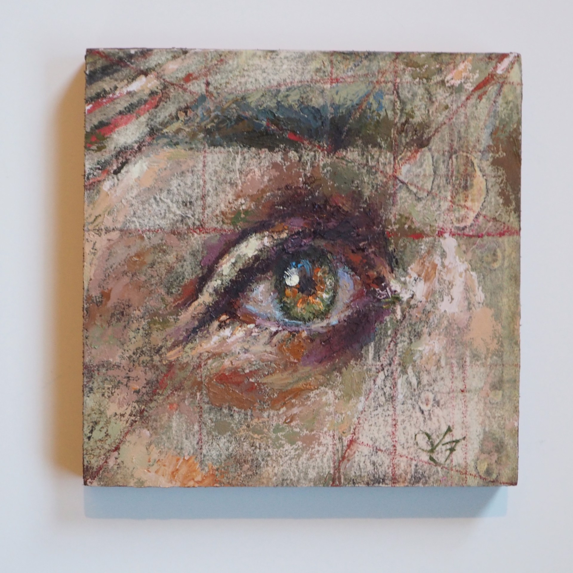 A painting of a woman's eye on a piece of paper.