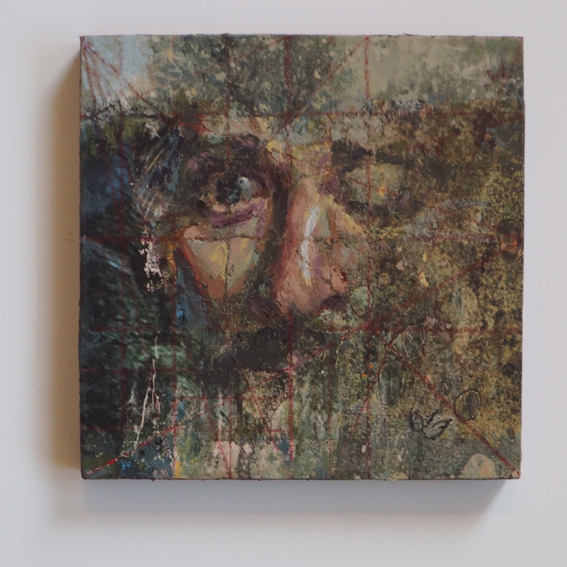 A painting of a woman's face on a piece of paper.