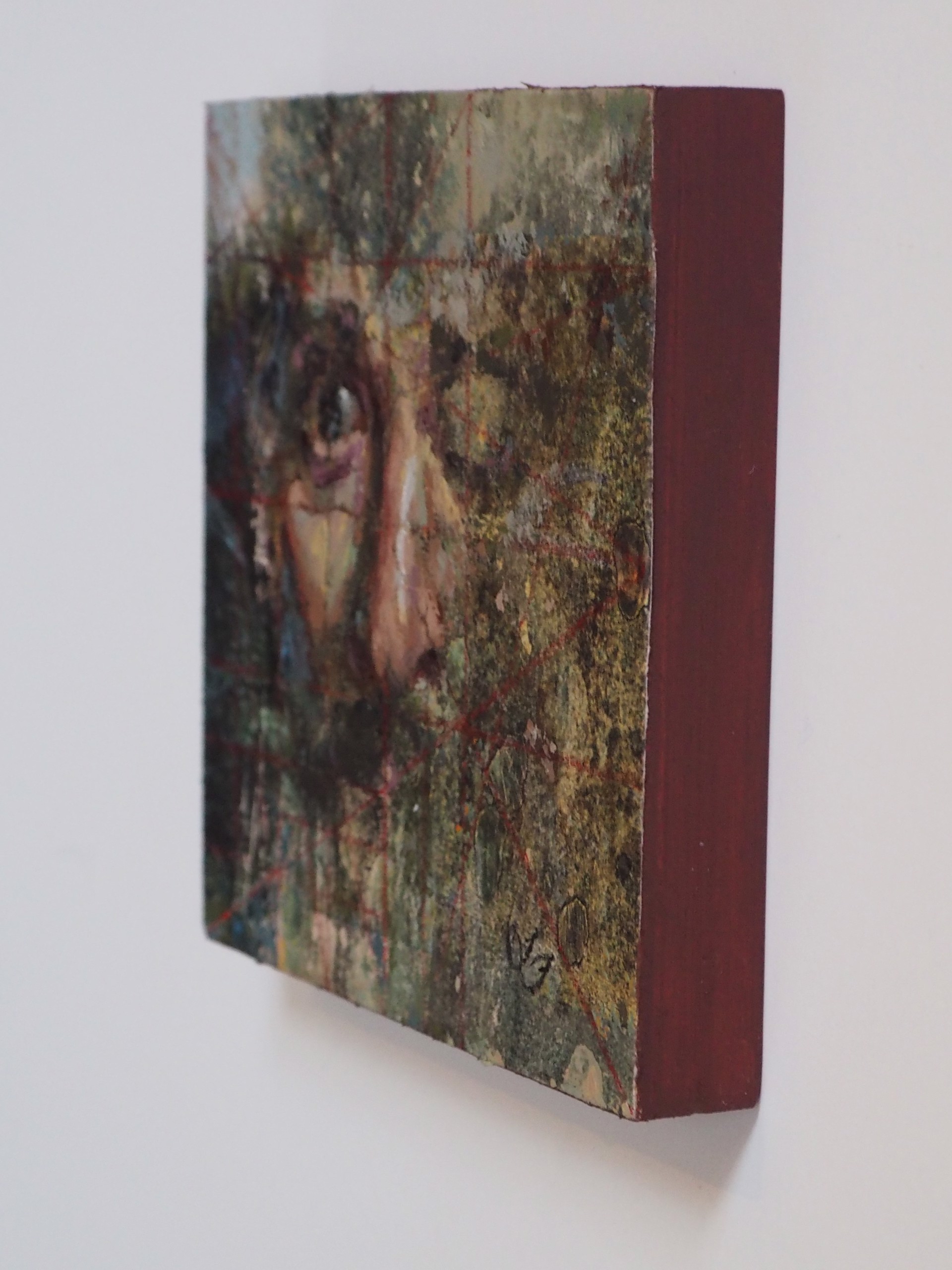 A painting of a woman's face on a piece of paper.