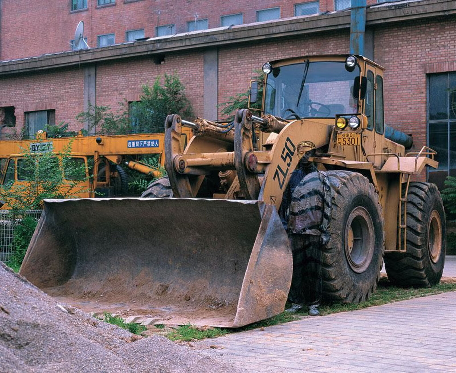 A picture of a bulldozer on a wall in a room.