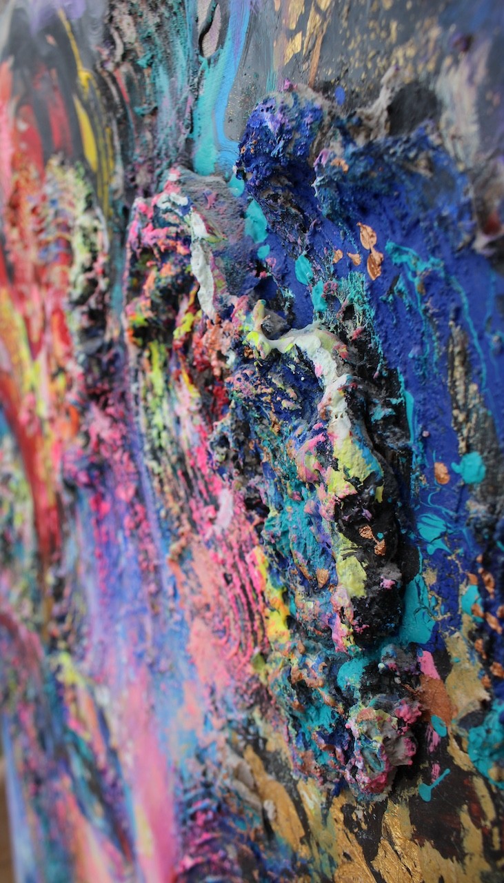 A painting of a woman's face with colorful hair.
