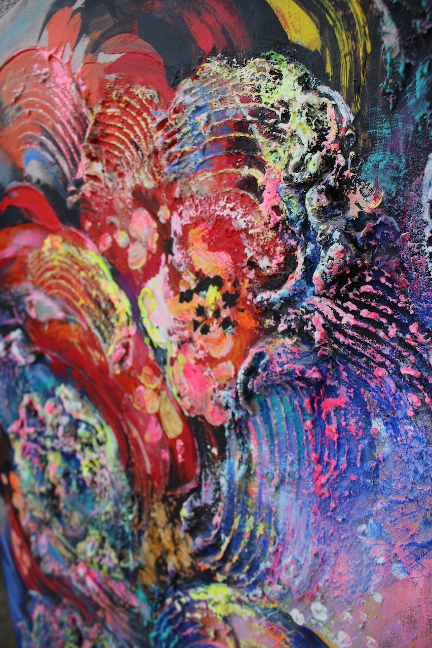 A painting of a woman's face with colorful hair.