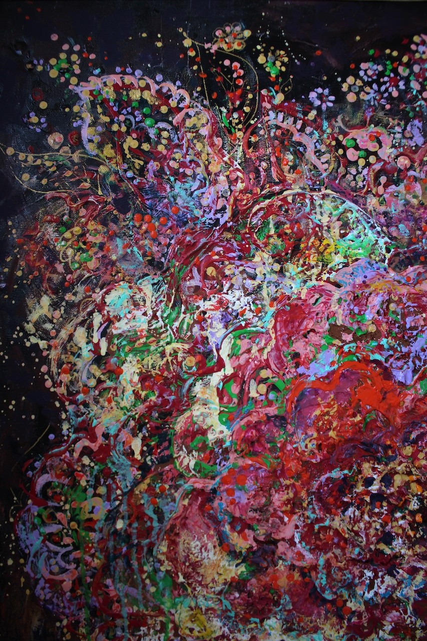 A vibrant abstract floral explosion bursting with reds, pinks, and greens against a dark void.